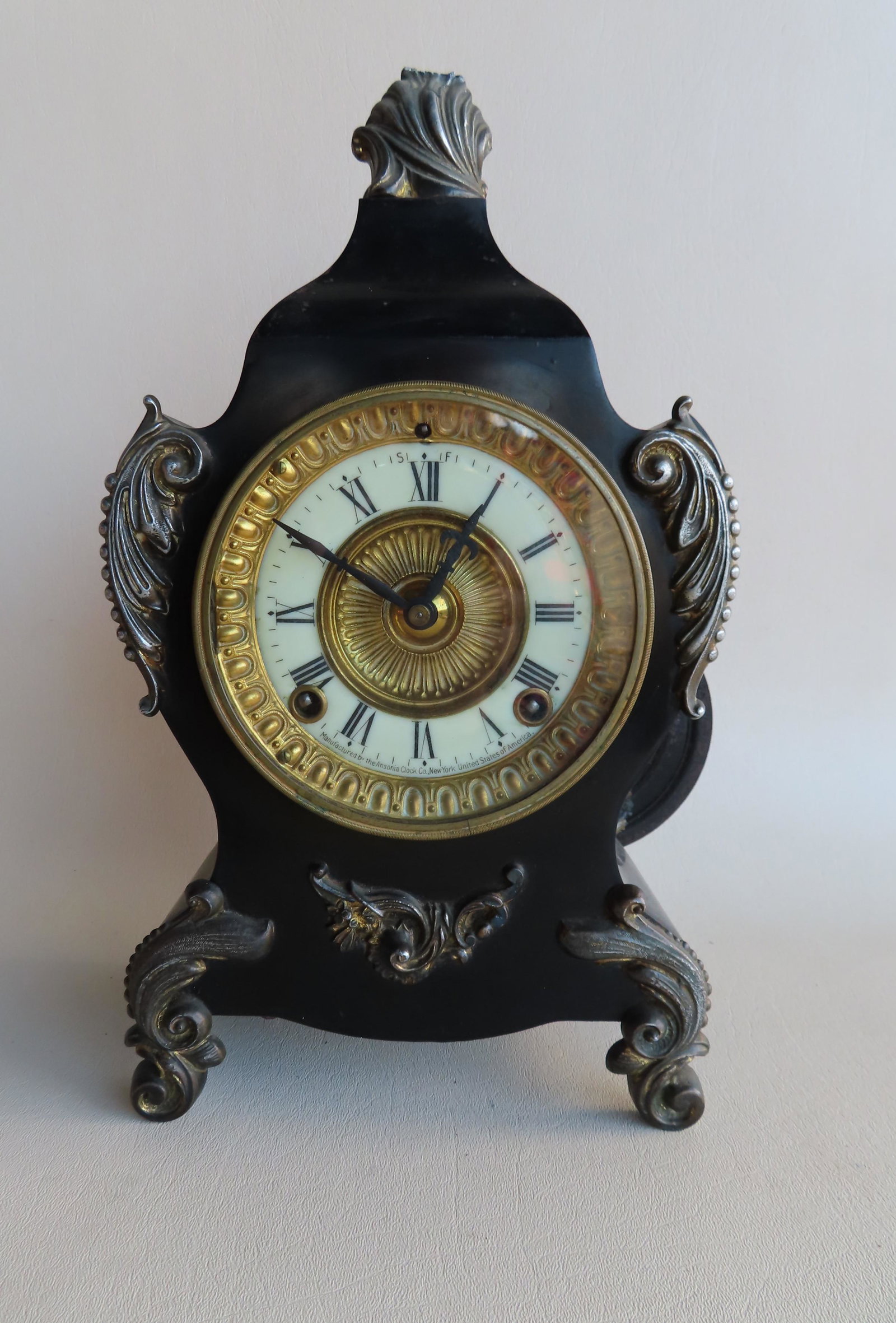 An Ansonia French style cast iron mantle clock, late: An Ansonia French style cast iron mantle clock, late 19th century. With pendulum and key, complete works, but sold as non-working. Measures 13 1/2"H x 71/2"W x 4"D. Circa 1900.