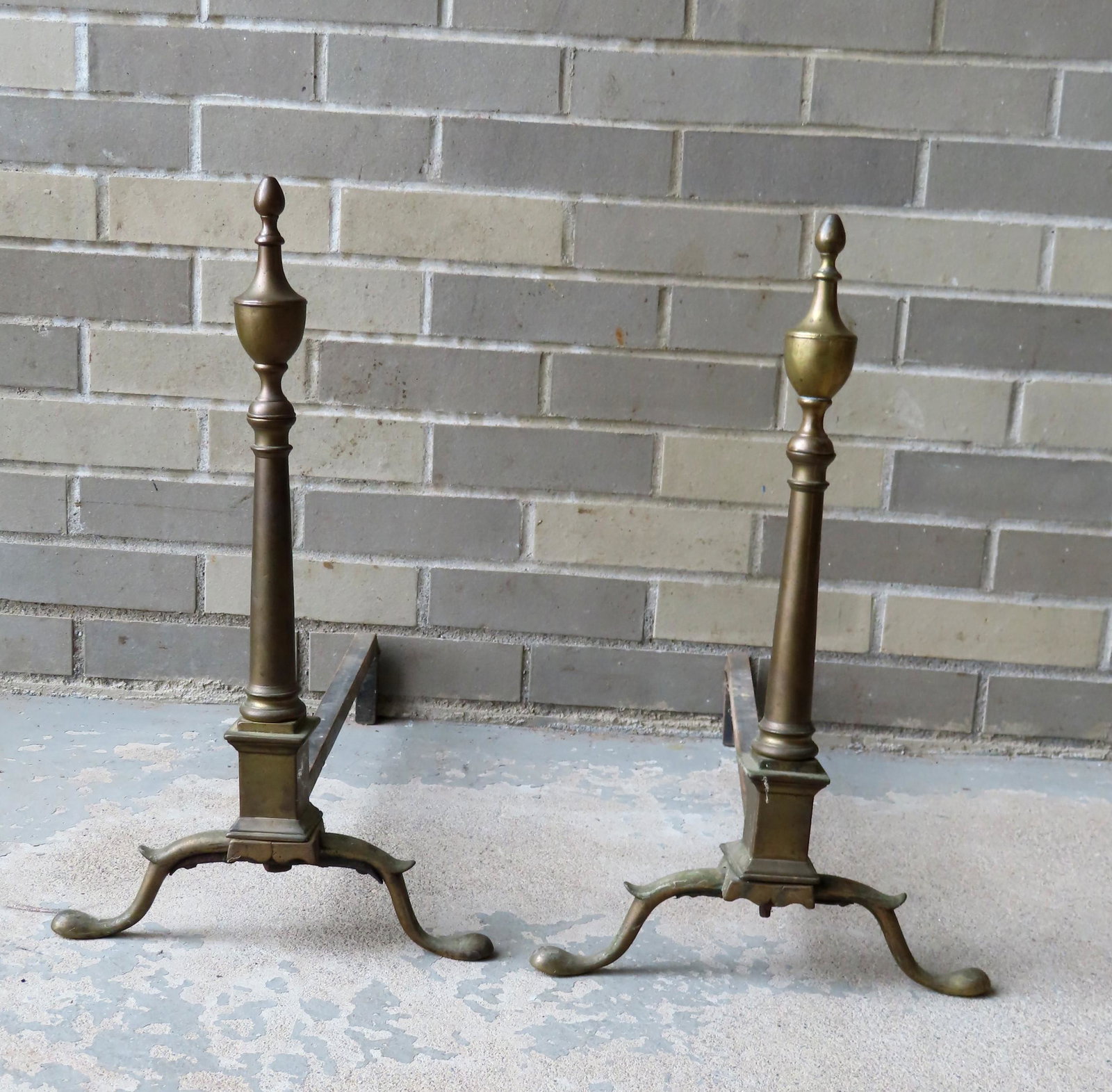 A pair of classical Federal brass andirons signed "R.: A pair of classical Federal brass andirons signed "R. Wittingham N. York" on plinth (active NY 18th/19th century), having urn finials, turned post leading to square plinth with spurred snake feet, lat