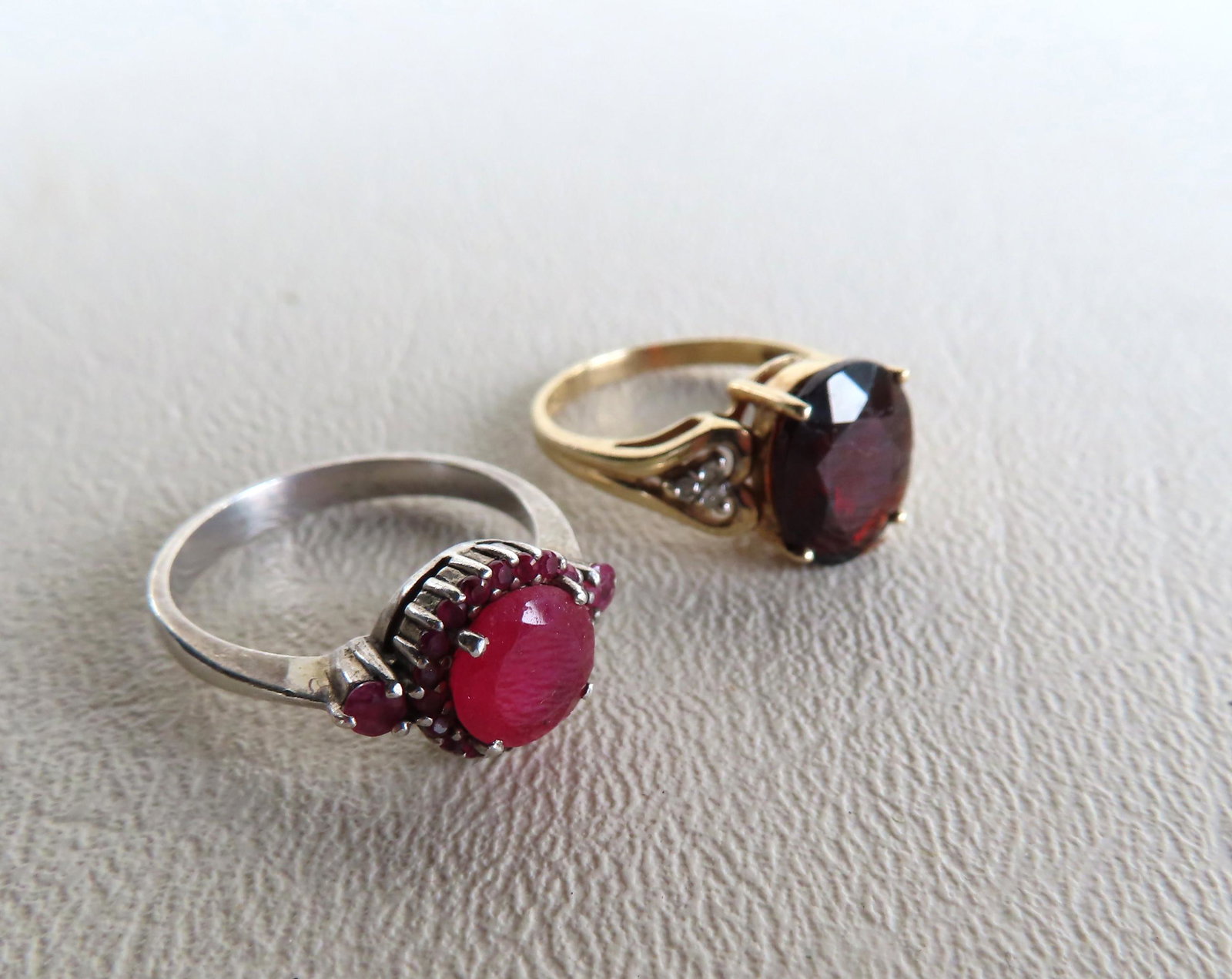 Two rings: The first in 10k with heart shaped garnets: Two rings: The first in 10k with heart shaped garnets and 3 diamonds on each side of mount; and a sterling ring with Siam rubies. Provenance: From the estate of pioneering AIDS physician, Dr. Joyce NY