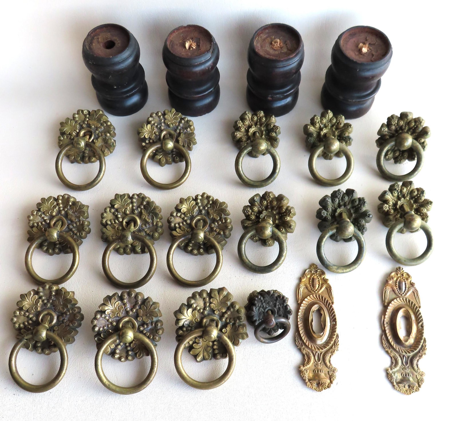 A grouping of Empire period furniture hardware: A grouping of Empire period furniture hardware including: 8 matching brass pulls with attached loop handles, decorated in the form of floral hearts and leaves; 6 matching floral shaped brass pulls wit