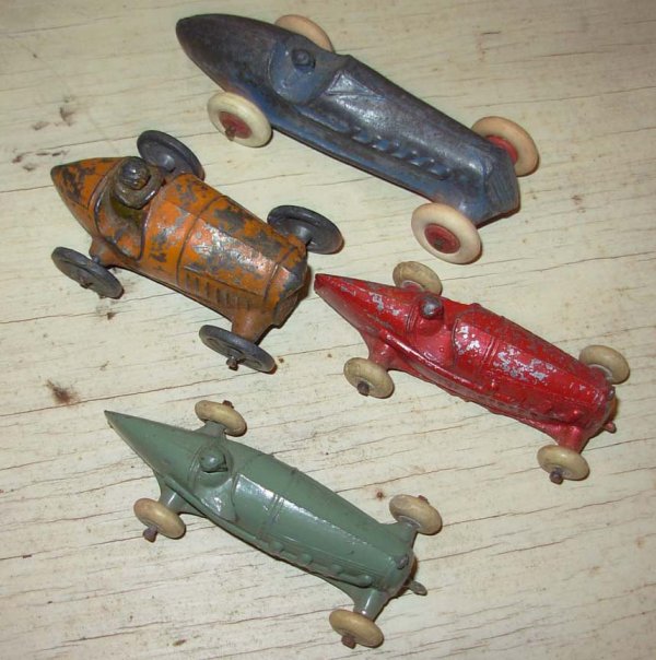 Barclay, Lincoln, Kansas Toy, C.A.W.?, Hubley : Barclay, Lincoln, Kansas Toy, C.A.W.? Slush, Four Race Cars; Orange car 2 3/4' lg fair cond, blue car 4" lg very good cond, and two 3 1/4' lg red and green very good to excl cond. Also Hubley vintage 