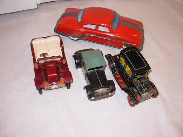 Japan tin friction cars: 10' Olds, 6 1/4" lg right: Japan tin friction cars: 10' Olds, 6 1/4" lg right hand drive antique car w/plastic lights, 6" black & yellow coupe and a 6" lg black w'blue trim antique car. All are in very good to exc. Cond,