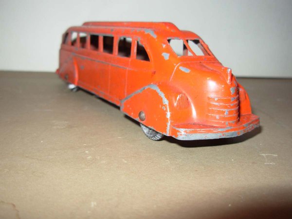 Metal Masters , Structo & Hubley Lot: Metal Masters Red Bus, 7 1/8" lg. Very good cond. & Structo/Hubley/? 4 piece lot;: 2 Structo Cadillac's 6" lg, orange & white Sedan 7" lg and a red Pickup truck 6 1/2" lg. all are in played with cond.