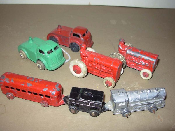 Barclay?? 7 piece lot; 2 red Farm Tractors 2 1/8" : Barclay?? 7 piece lot; 2 red Farm Tractors 2 1/8" lg very good cond, 2 trucks one green one red 2 1/2" lg excl cond and a 3 piece train 6 1/2" lg, the tender is marked NYCRR in very good cond PLUS Bar