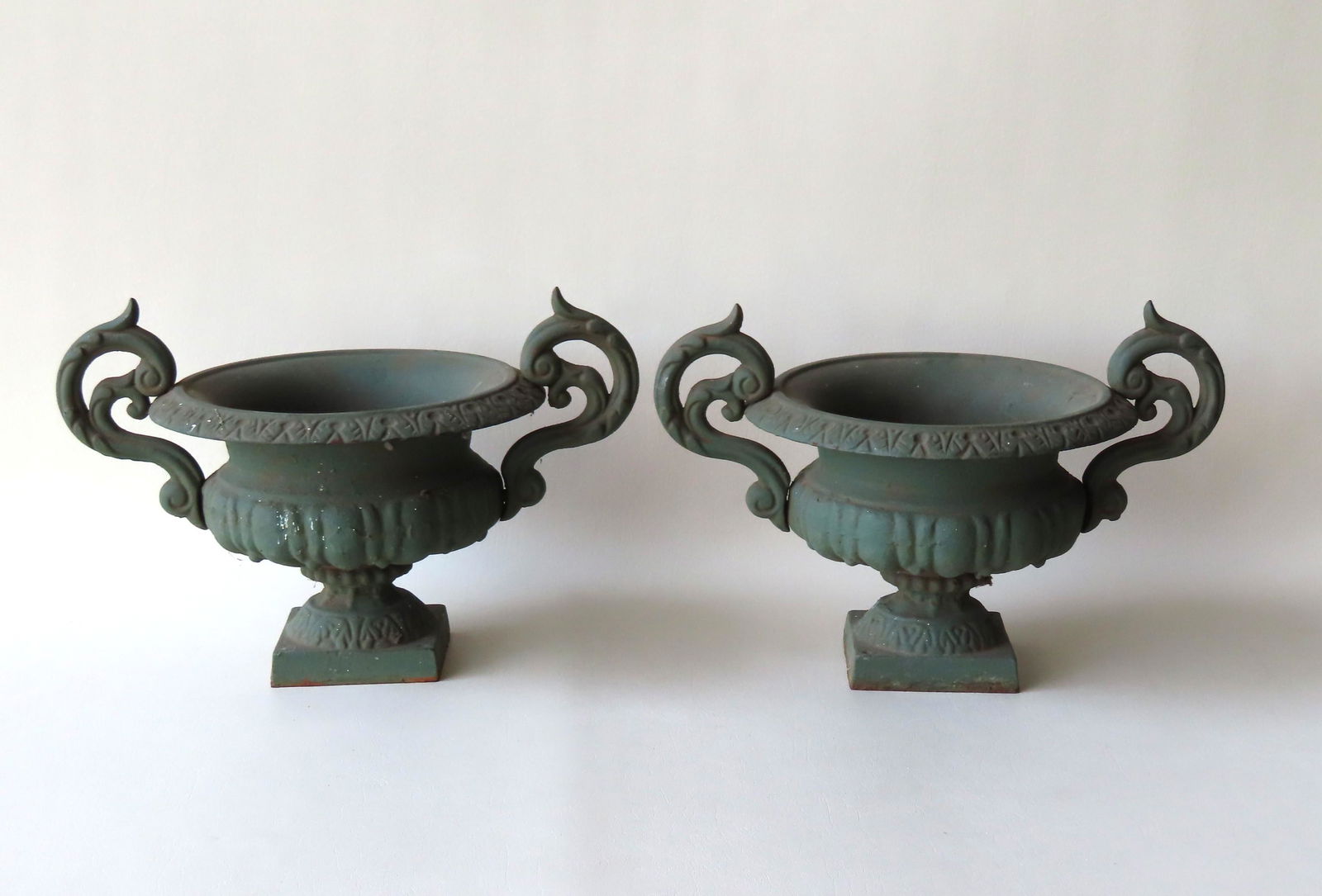 A small pair of cast iron table top garden urns with (1 of 6)