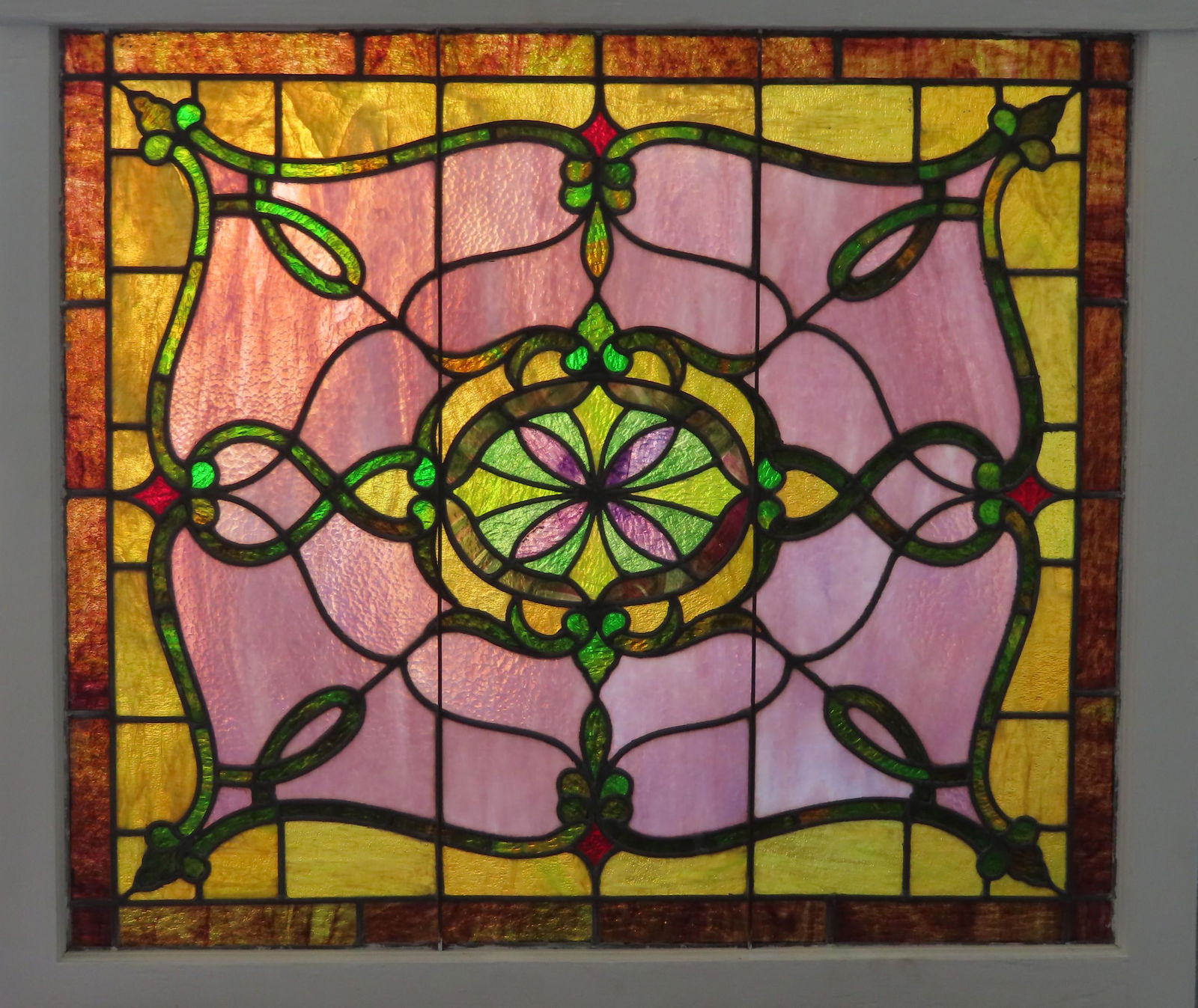 A good Art Nouveau period stained and leaded glass: A good Art Nouveau period stained and leaded glass window, late 19th century, very good condition (newer paint on wooden frame) - no damage. Measures 34" x 29 1/2" x 1 3/4" thick.