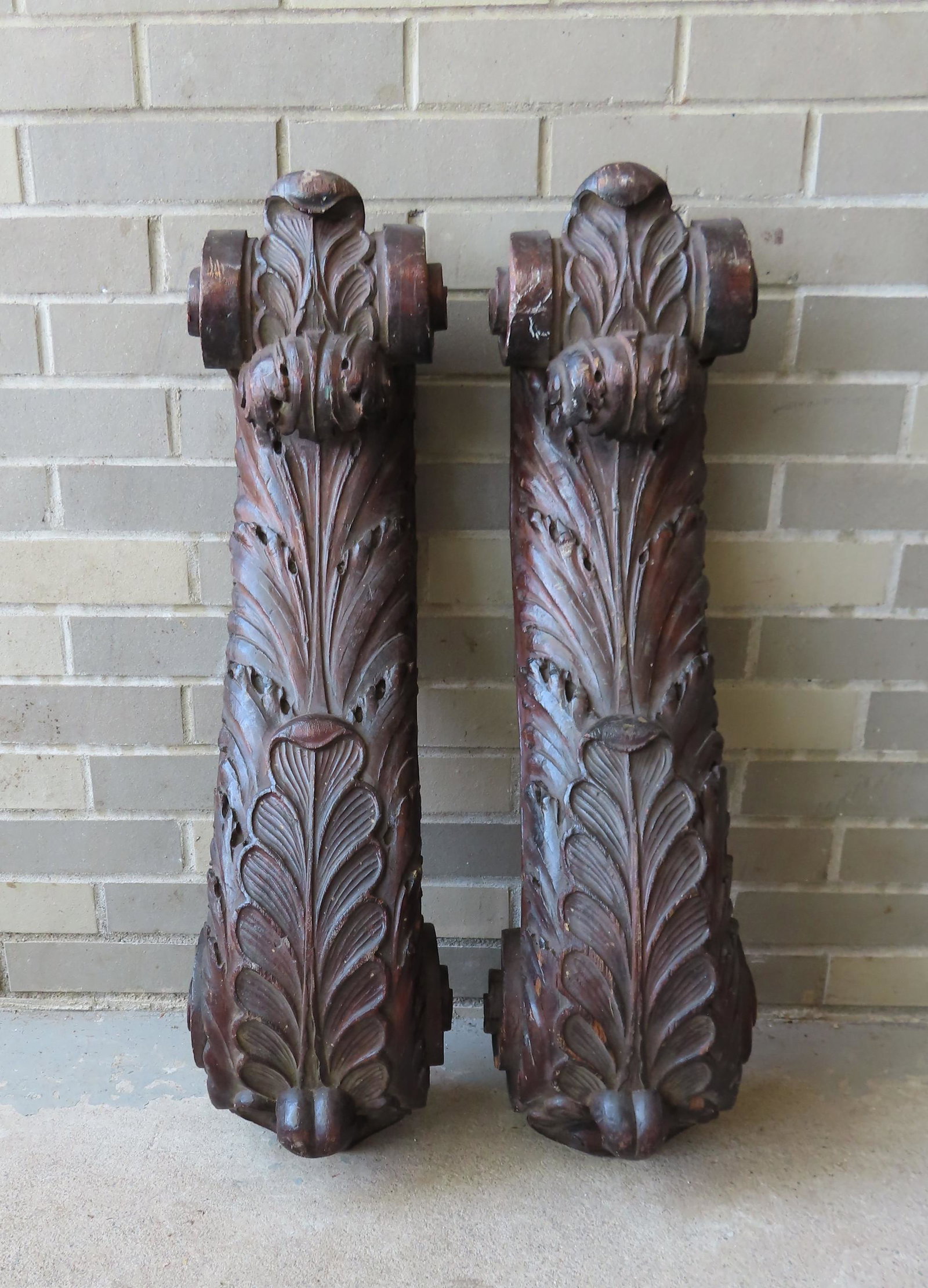 Two large matching carved wooden ornaments with: Two large matching carved wooden ornaments with acanthus decorations and scrolled ends, 19th century. Both with minor surface abrasions and overall in very good condition. Each measures approximately 