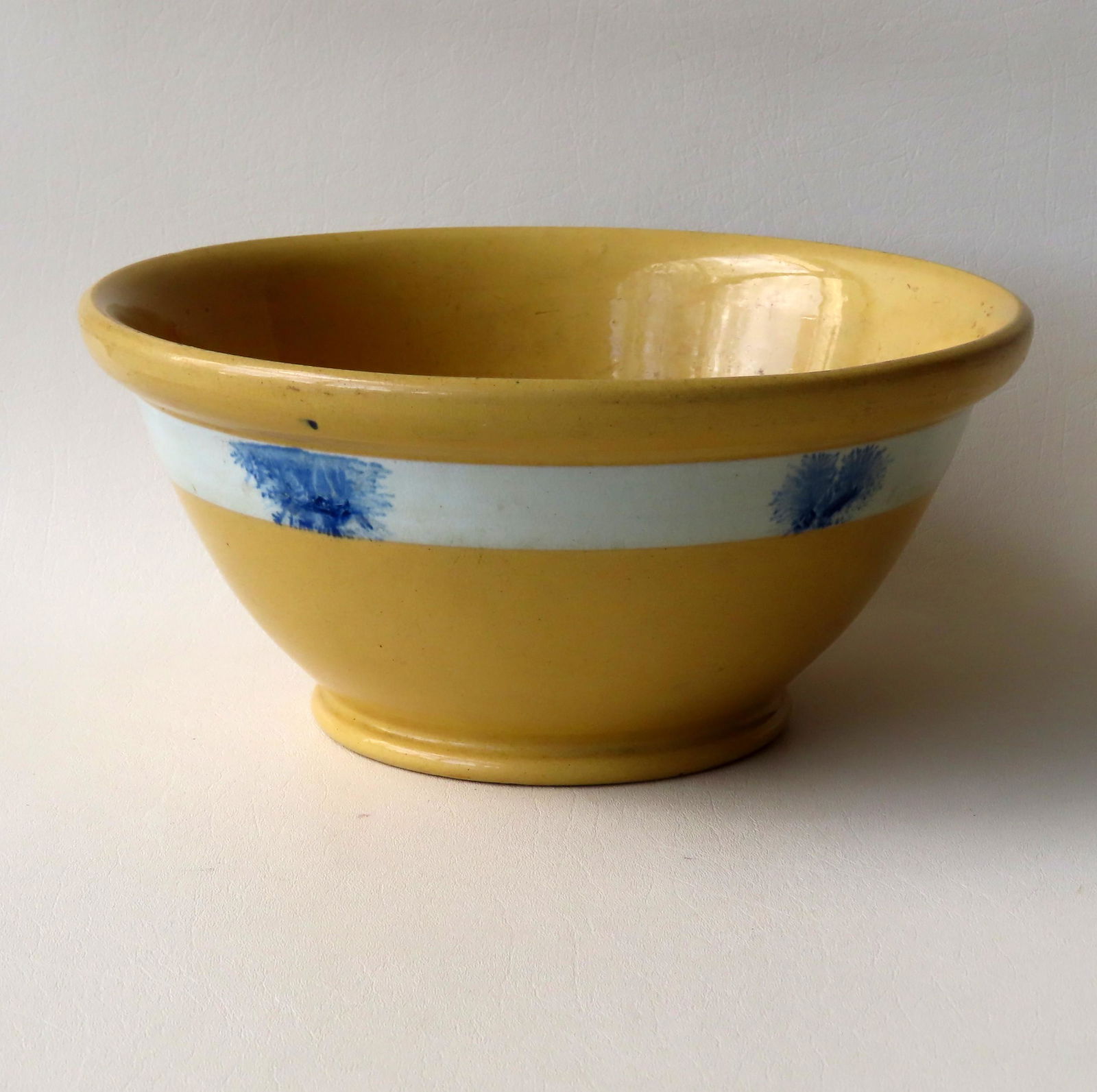 A large yellowware mocha bowl with rolled rim and white (1 of 4)