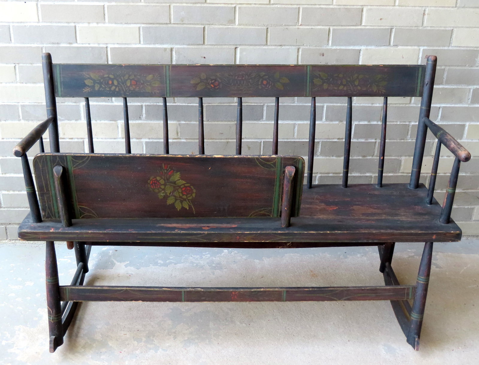 A Sheraton stenciled spindle-back mammy's bench in: A Sheraton stenciled spindle-back mammy's bench in original paint and stenciling retaining original child's removable seat restraint, circa 1830, very good condition. Measures 46 3/4"W x 24 1/2"D x 31