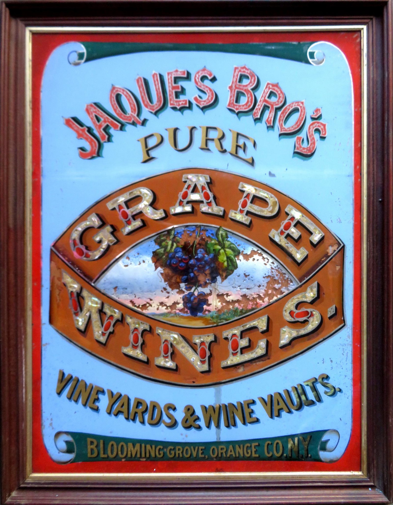 Colorful 19th century advertising sign, hand painted in: Colorful 19th century advertising sign, hand painted in reverse on glass "JAQUES BRO'S. / PURE GRAPE WINES / VINEYARDS & WINE VAULTS / BLOOMING GROVE, ORANGE Co., N.Y." - original black walnut frame, 