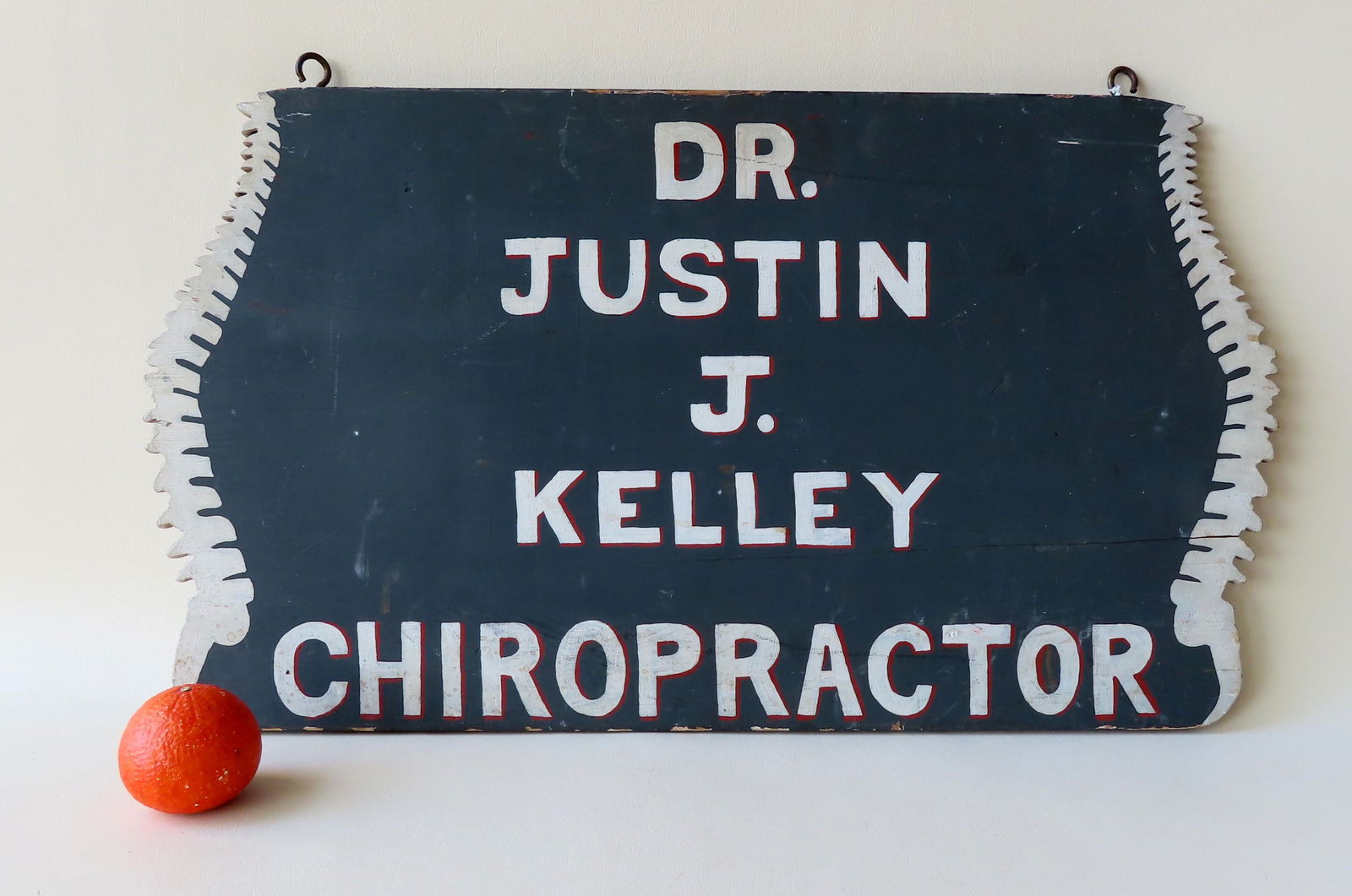 A chiropractor's doubled sided trade sign in white (1 of 4)