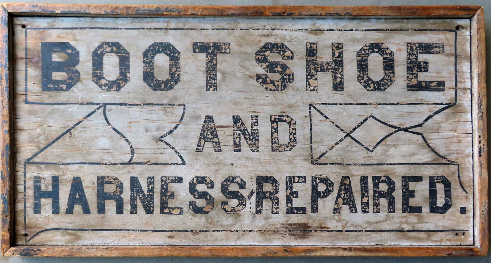 A wooden country store sign marked "BOOT - SHOE AND: A wooden country store sign marked "BOOT - SHOE AND HARNESS REPAIRED, double sided with original wooden frame - square nail construction - third quarter 19th century. One side in original paint with w