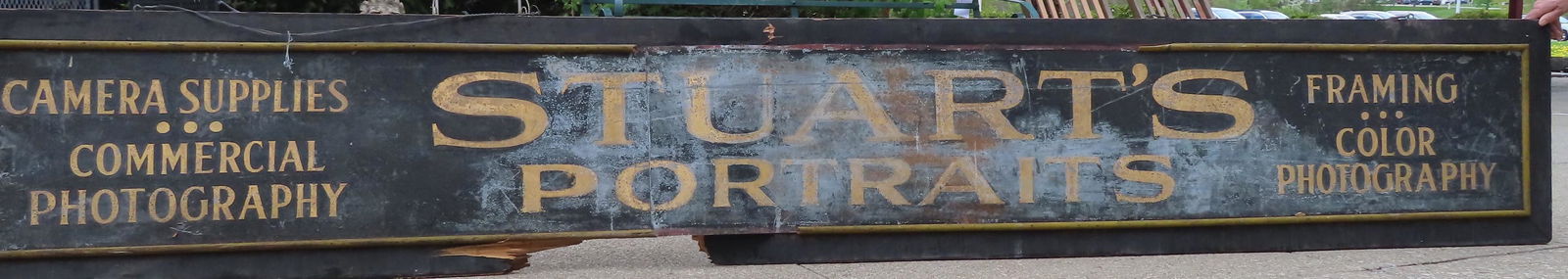 Tin sign with wood border marked "Camera Supplies / (1 of 6)