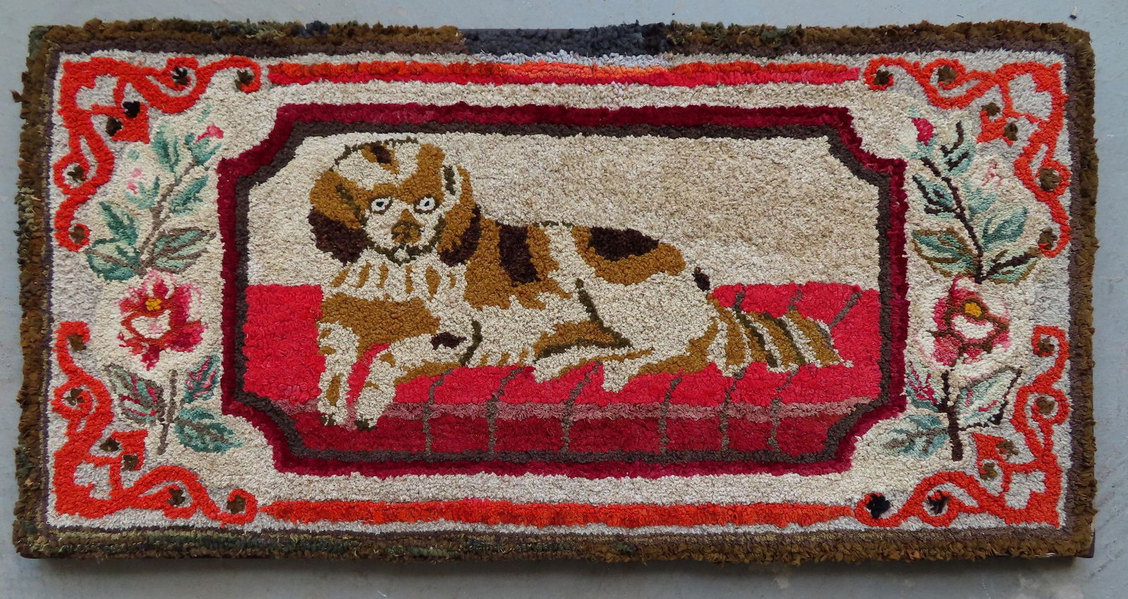 Hooked rug of a King Charles Spaniel resting on brick (1 of 4)