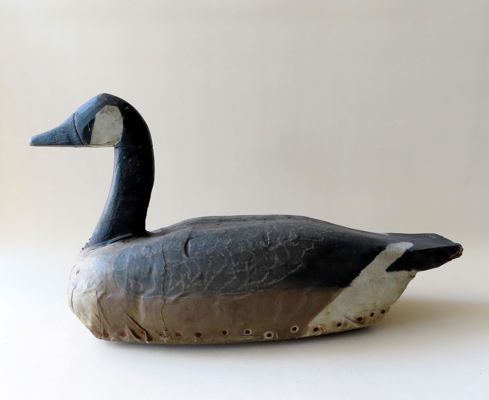 A primitive hand made canvas covered wooden goose decoy (1 of 5)
