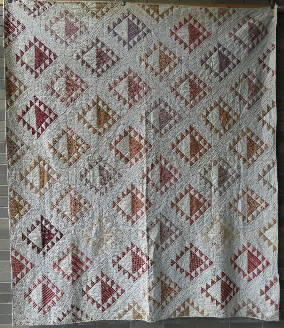 A patchwork quilt, decorated with Flying Geese patches, (1 of 5)