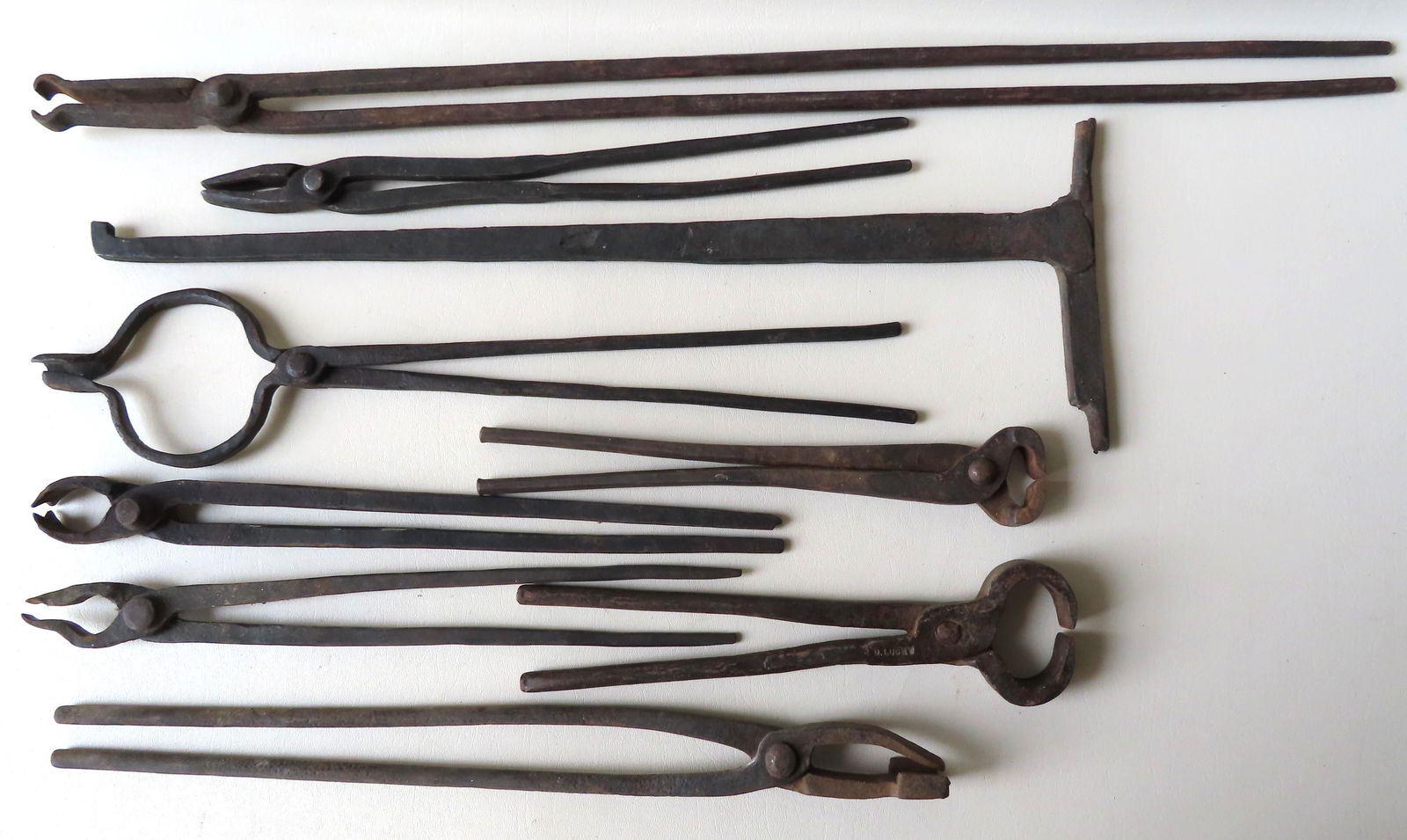 Grouping of 8 hand forged iron blacksmith tongs - the (1 of 6)