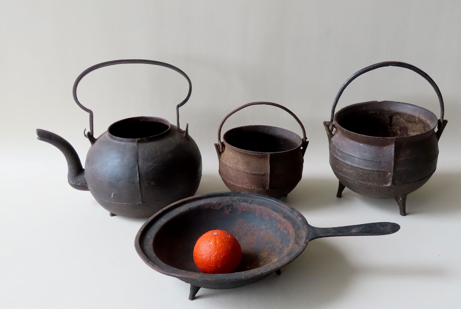 A grouping of 4 cast iron hearth items some with losses (1 of 7)