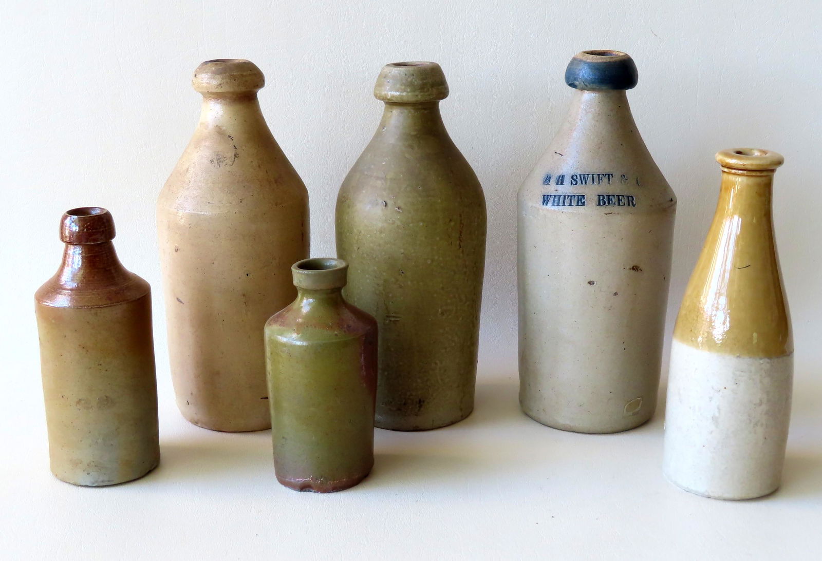 Grouping of 6 ink and beer stoneware bottles. One beer (1 of 9)
