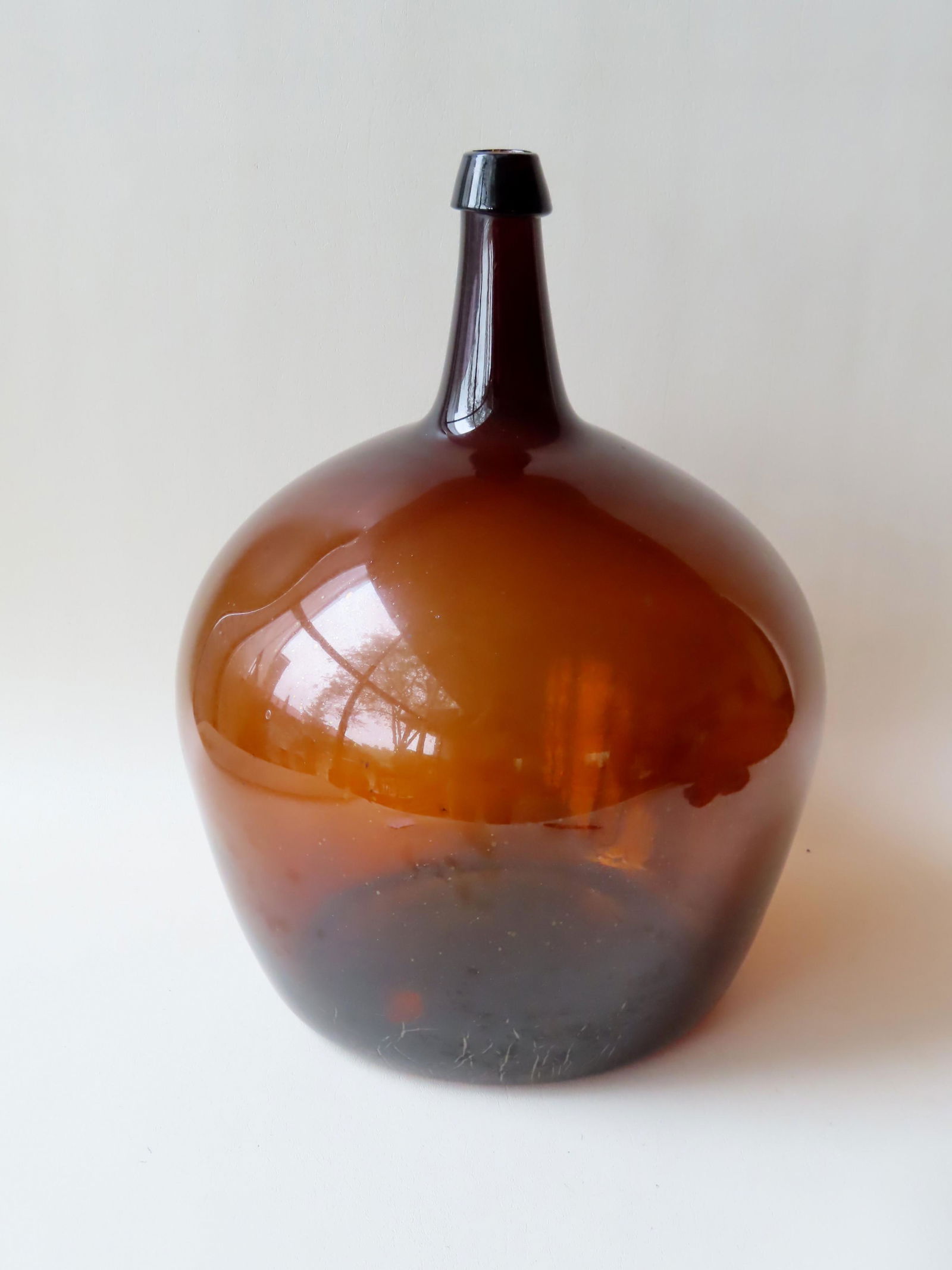 A large dark amber demijohn bottle with tapered mouth (1 of 6)