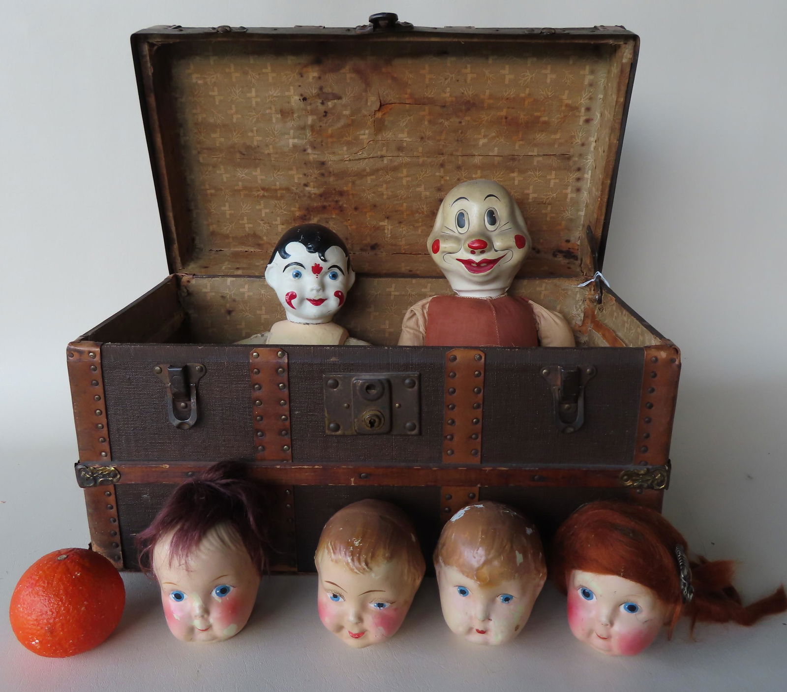 A doll size trunk with miscellaneous dolls and parts (1 of 5)