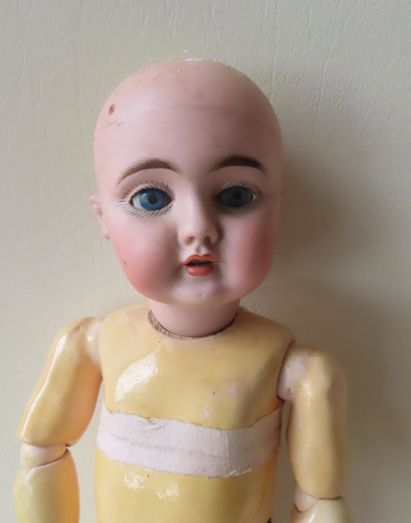 Kestner German bisque head doll marked "Made in Germany: Kestner German bisque head doll marked "Made in Germany / 143 / B 6". The doll with mama- paper cryer pull strings on side of body, hand painted facial features, open mouth with teeth, blue sleep eyes