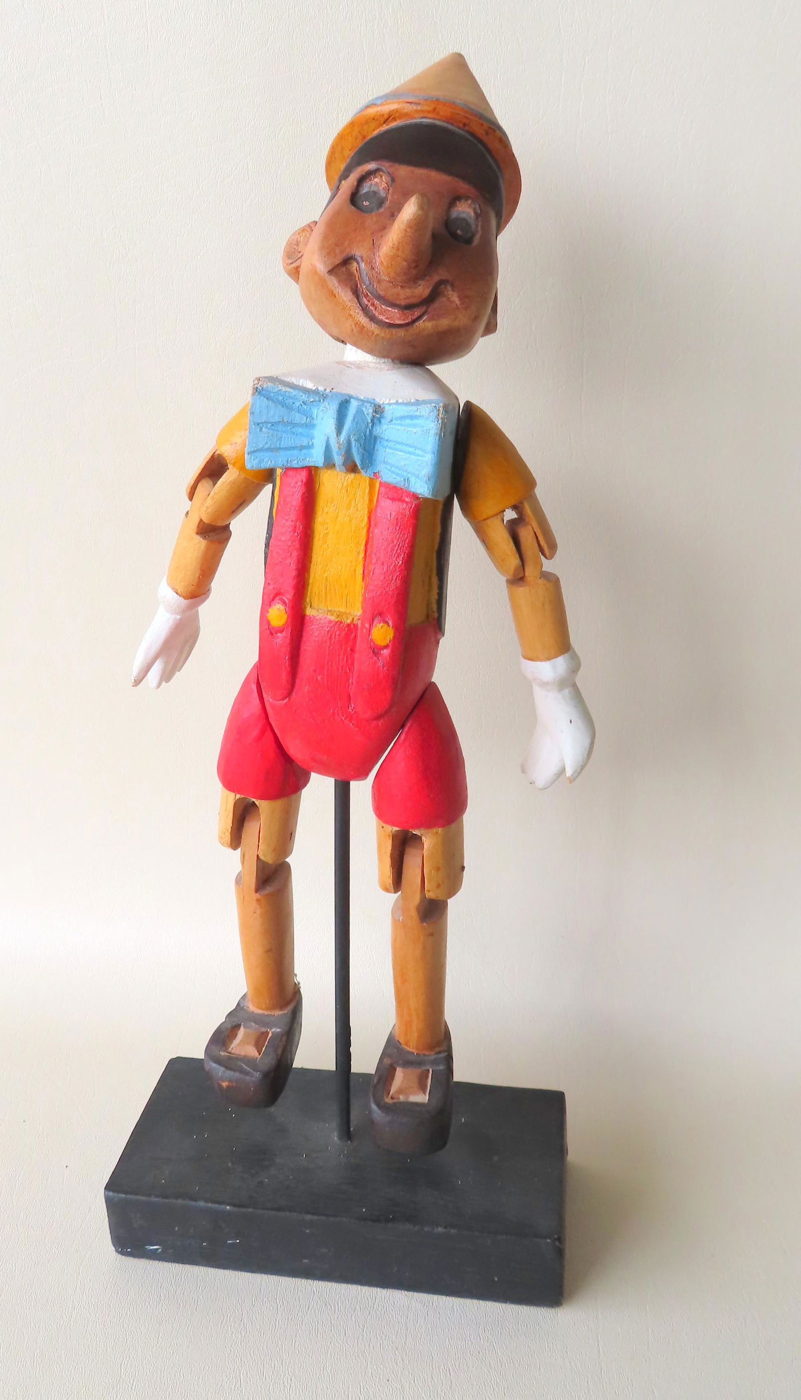 Carved wooden Pinnochio puppet mounted on stand, (1 of 4)