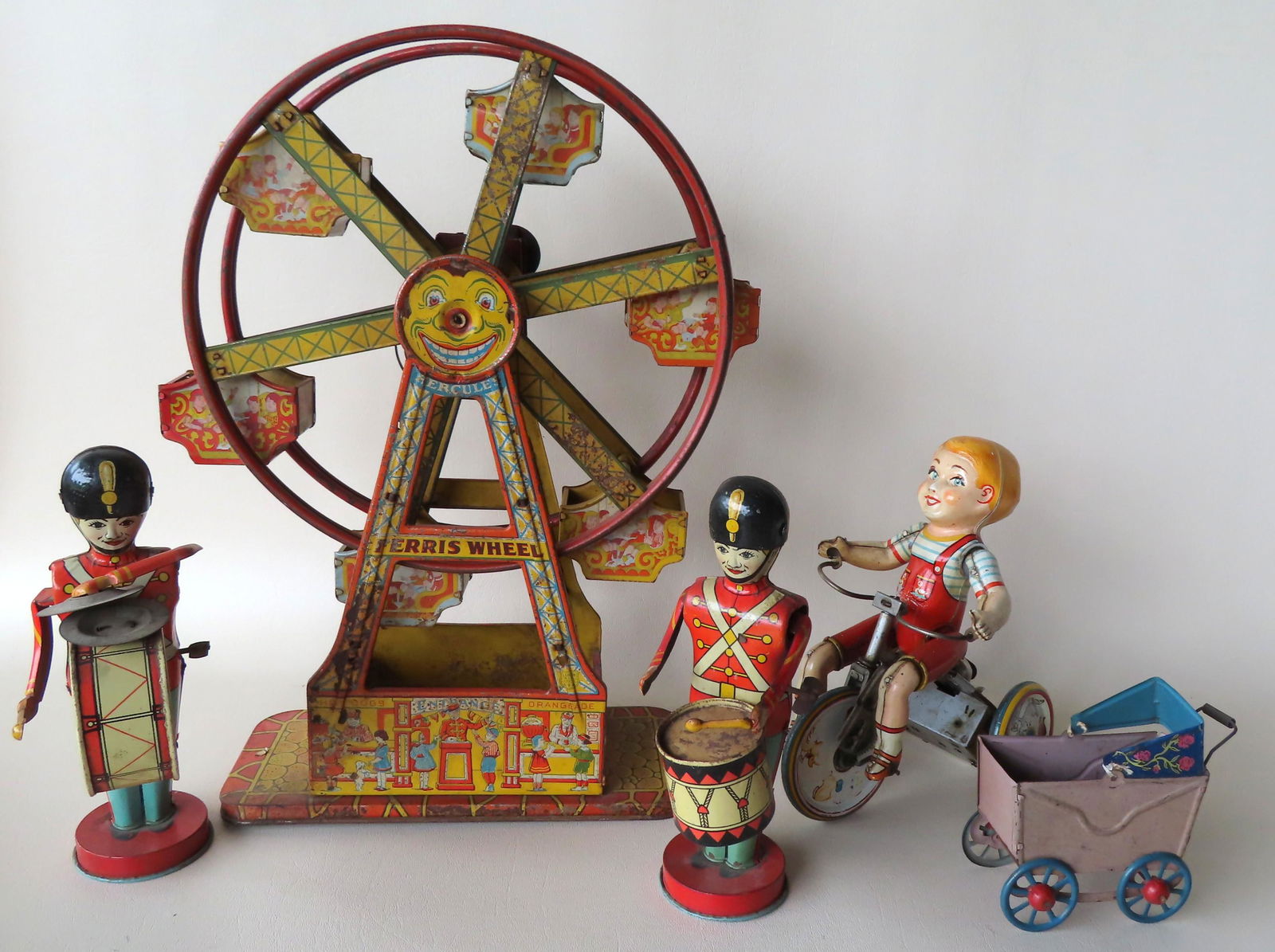 Four lithograph tin windup toys and a painted tin doll (1 of 13)