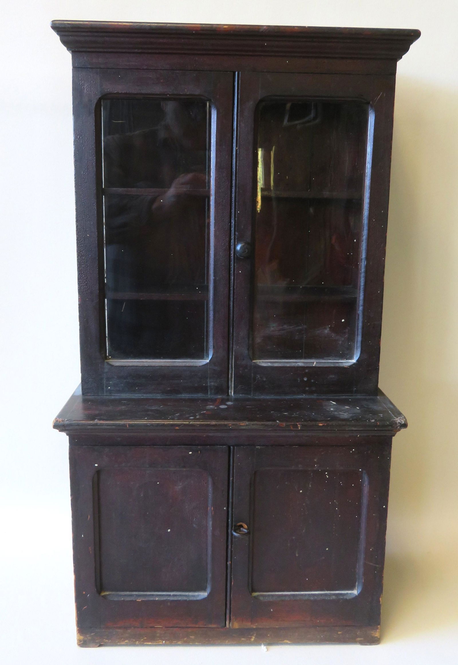A handmade child's china cabinet filled with various: A handmade child's china cabinet filled with various vintage doll china and glassware. The china cabinet, circa 1900, is in original darkened finish, good condition, and measures 16 1/4"W x 8 3/4"D x