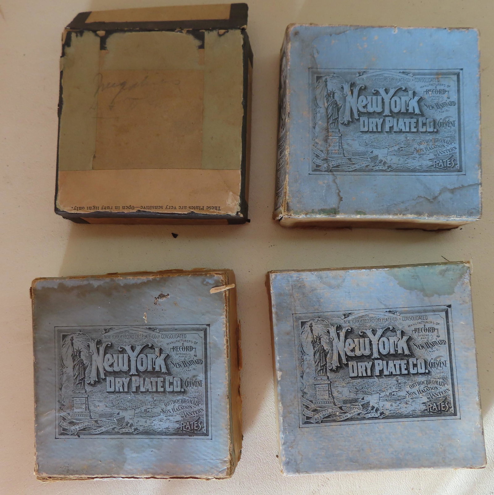 Grouping of 4 boxes of glass negative photos, probably: Grouping of 4 boxes of glass negative photos, probably late 19th century, totaling 45 images. Includes photos of sail boating, Victorian houses, family members, military encampment (probably Spanish A