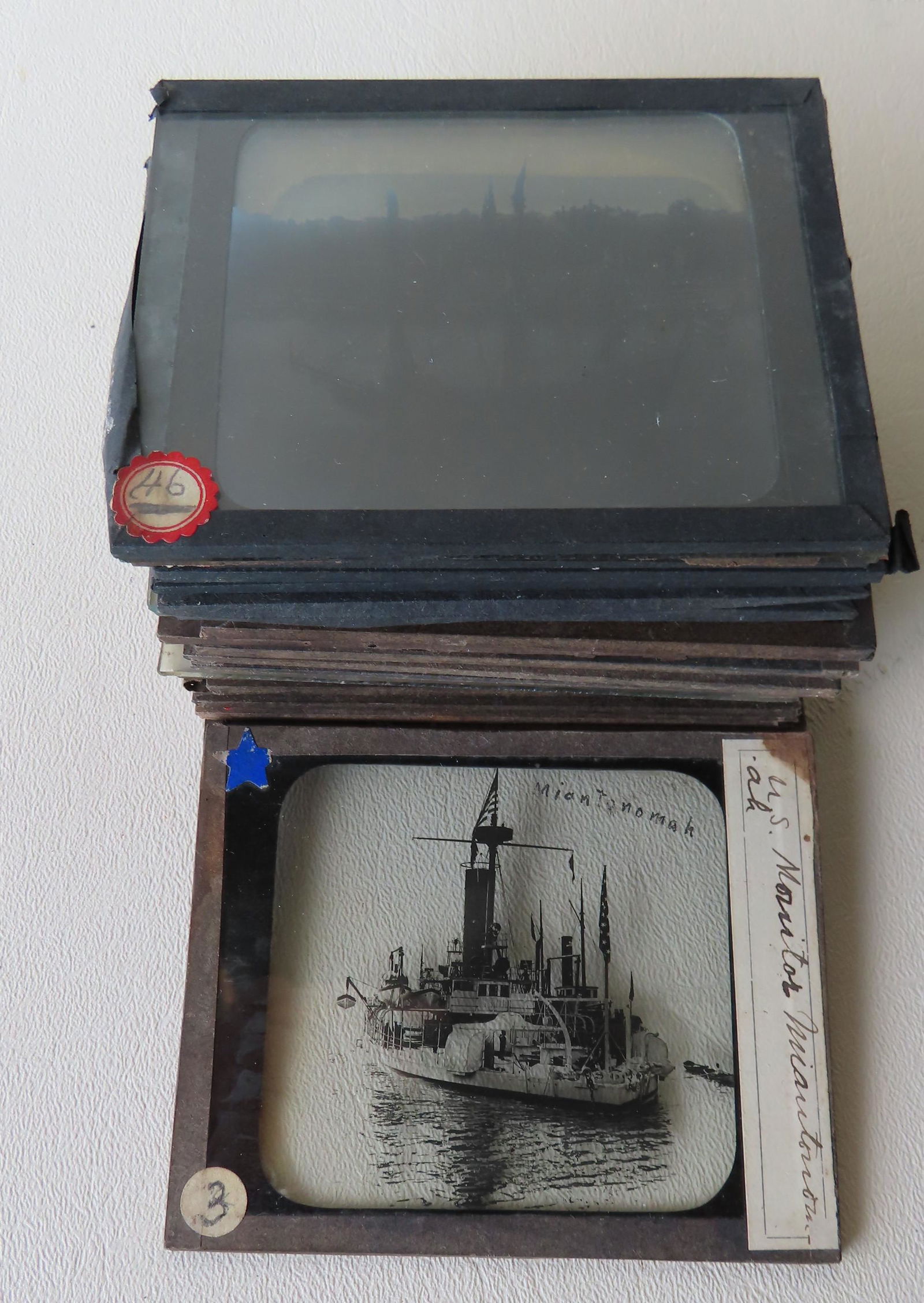 Grouping of 22 positive photographic slides of ships: Grouping of 22 positive photographic slides of ships and boats including paddlewheeler, several US battleships signed Gould W. Hart - Brooklyn NY, tug boat named "Robert Burnett" with pilot house eagl
