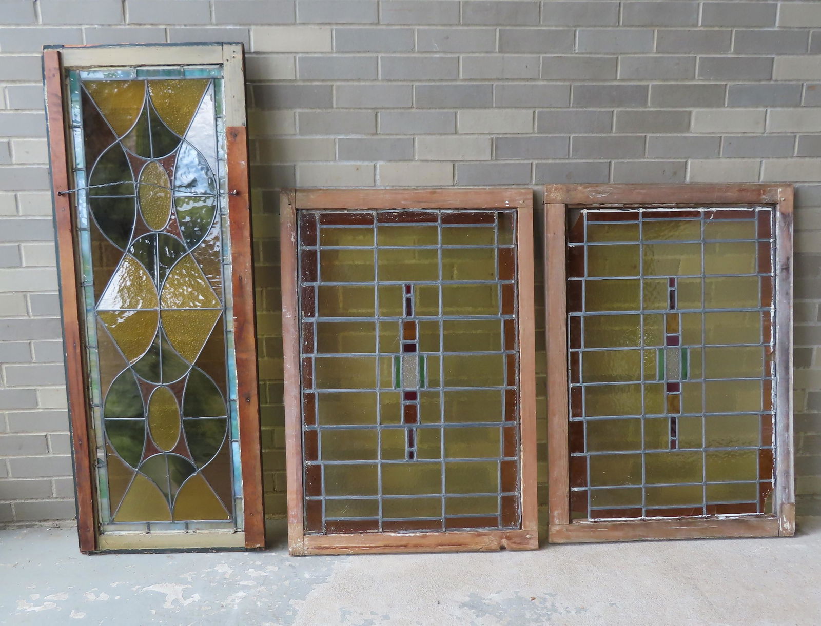 Three leaded and stained glass windows including: Two: Three leaded and stained glass windows including: Two matching in the manner of Frank Lloyd Wright - 26 1/2" x 38 1/2" - both with minor glass losses in small sections of glass in corners (see photos)