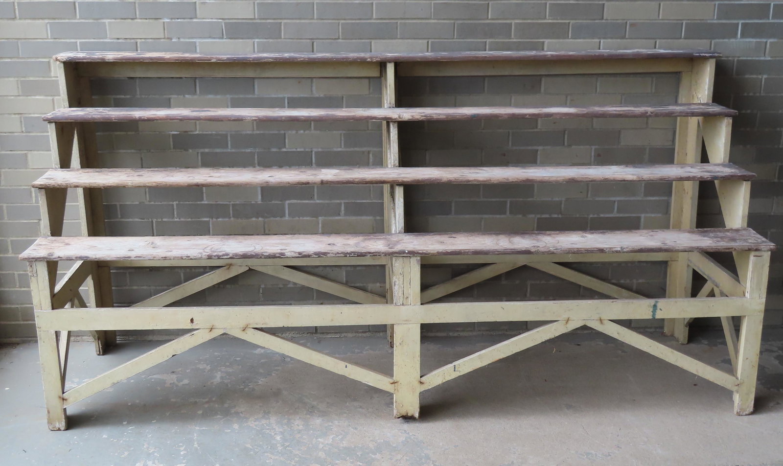 A large roadside farm stand, circa 1950. The 4 tier: A large roadside farm stand, circa 1950. The 4 tier stand, with framed cross-stretcher supports, is very sturdy and measures 91"W x 29"D x 44 1/2"H. The base of the center leg is slightly worn, else i