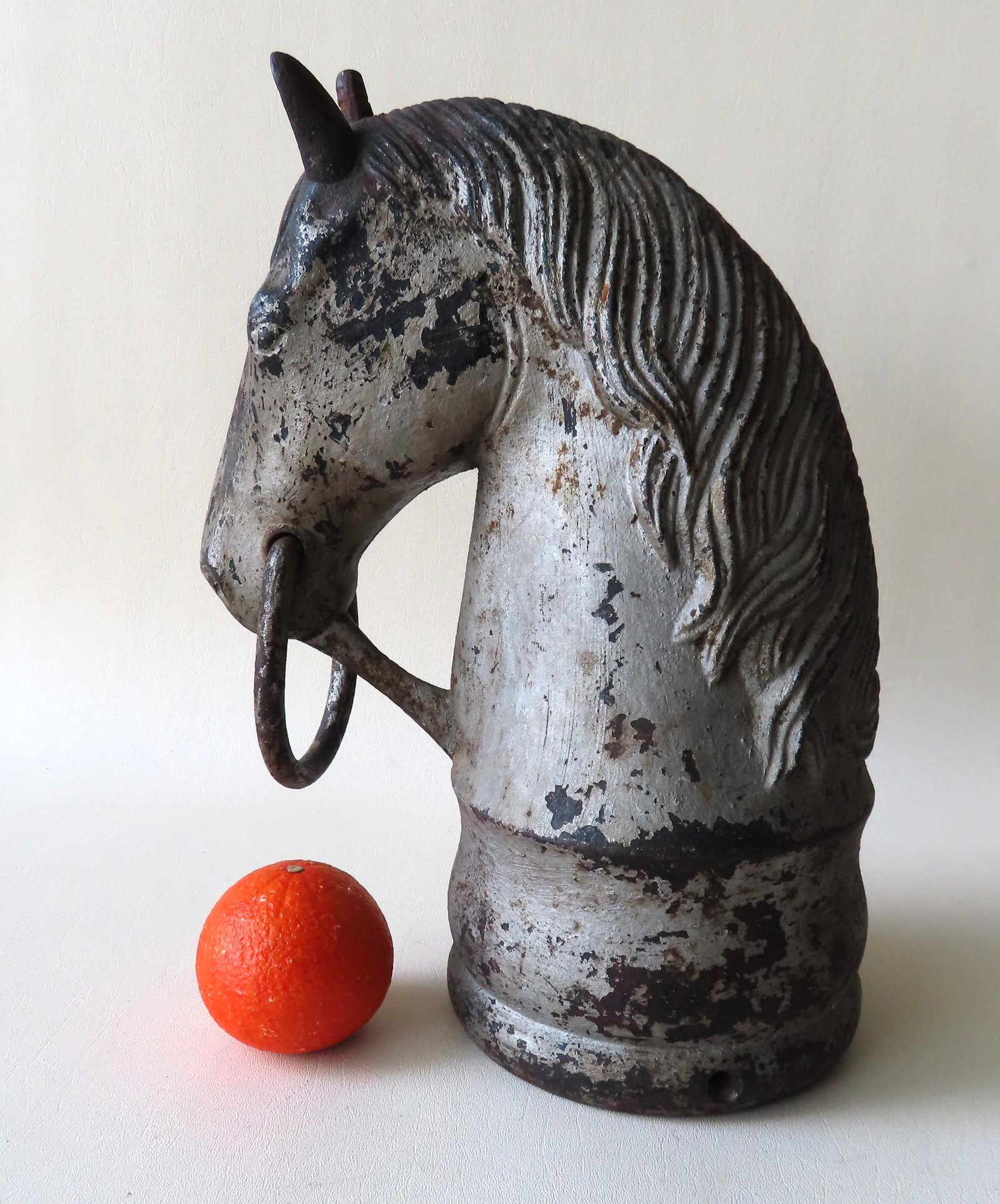 Cast iron horse head hitching post with detailed mane: Cast iron horse head hitching post with detailed mane and original iron tie-down ring hanging from mouth, 19th century. One ear has been replaced with a similar iron ear, otherwise very good condition