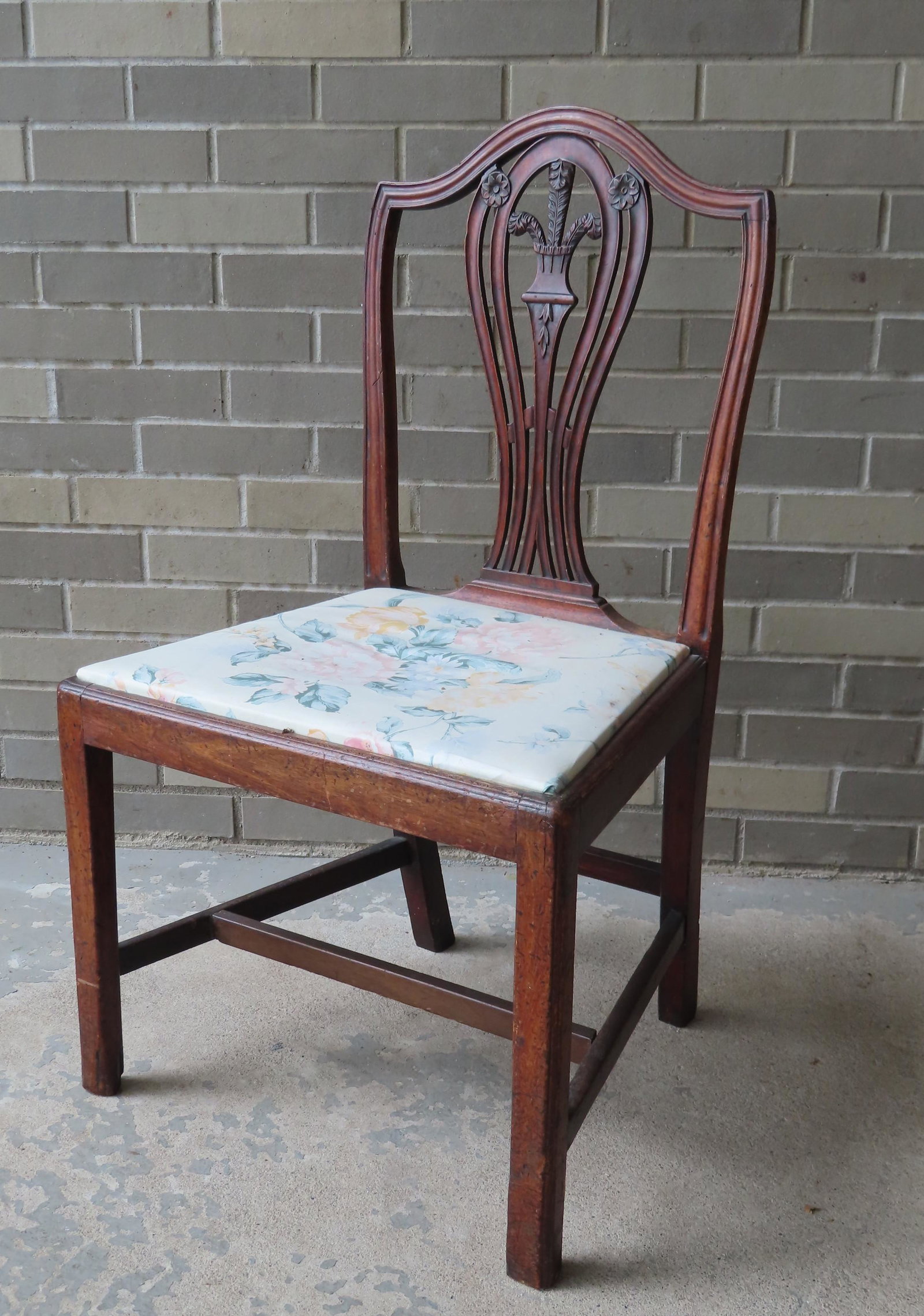 A transitional Chippendale side chair having a shield: A transitional Chippendale side chair having a shield back with carved sheaf of wheat design and having square beaded legs with cross stretches, circa 1800. Some use wear, but overall good condition.