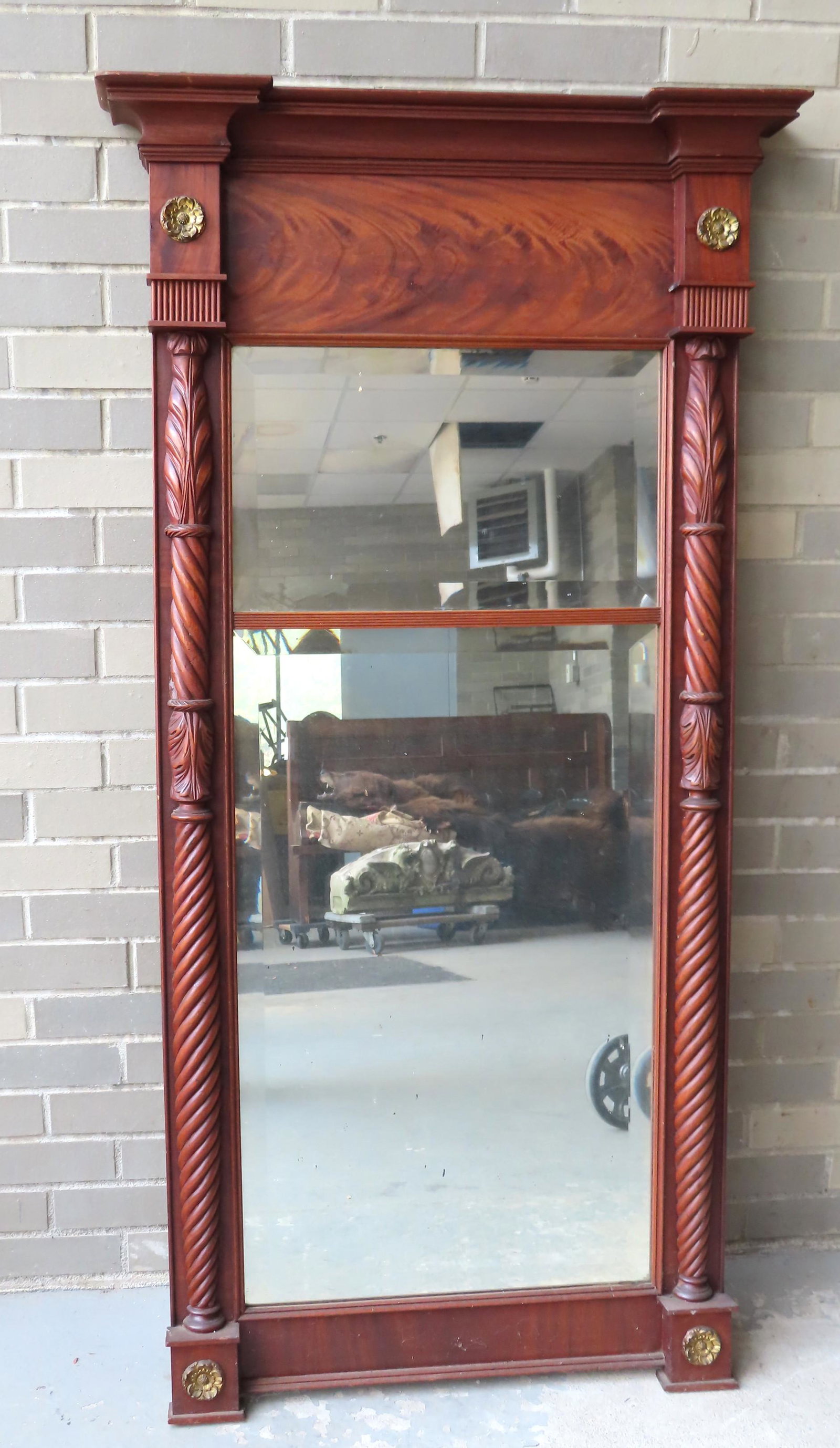 Large NY State Sheraton mahogany wall mirror having: Large NY State Sheraton mahogany wall mirror having acanthus and rope twist 1/2 columns with brass rosette terminals, flanking the double paneled beveled glass mirrors, circa 1830-40. The mirror measu