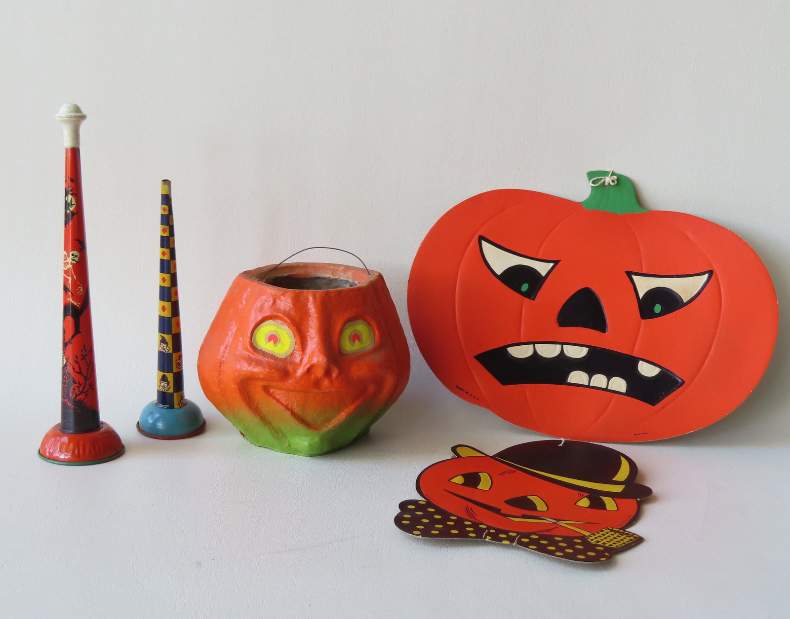 Grouping of 5 Halloween collectibles including: Paper: Grouping of 5 Halloween collectibles including: Paper mache Jack-O-Lantern with tin bale handle (selling price of 25 cents marked on base) - very good condition; 2 lithographed noise makers (one missi