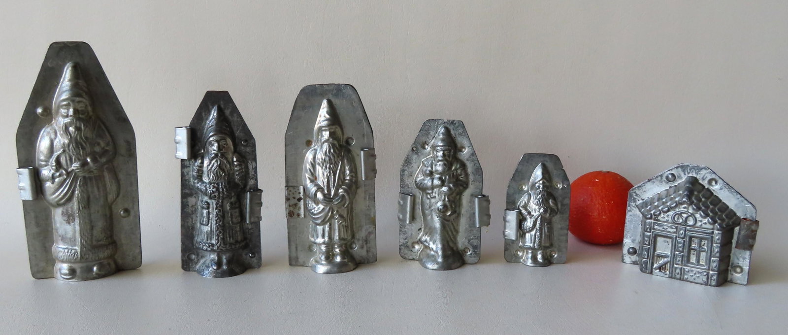 Grouping of 5 Santa Claus double chocolate molds with: Grouping of 5 Santa Claus double chocolate molds with open bottoms, and 1 double gingerbread house chocolate mold with open bottom - all with double clips. Includes the largest marked #1029, similar t
