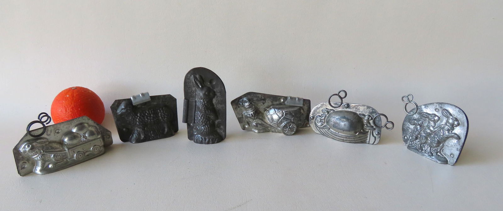 Grouping of 6 Easter related double chocolate molds: Grouping of 6 Easter related double chocolate molds with open bottoms including: 3 rabbits No. 6382 - 15; rabbit pulling Easter egg cart signed H. Walter - Berlin; a lamb marked no. 1 on both sides; a