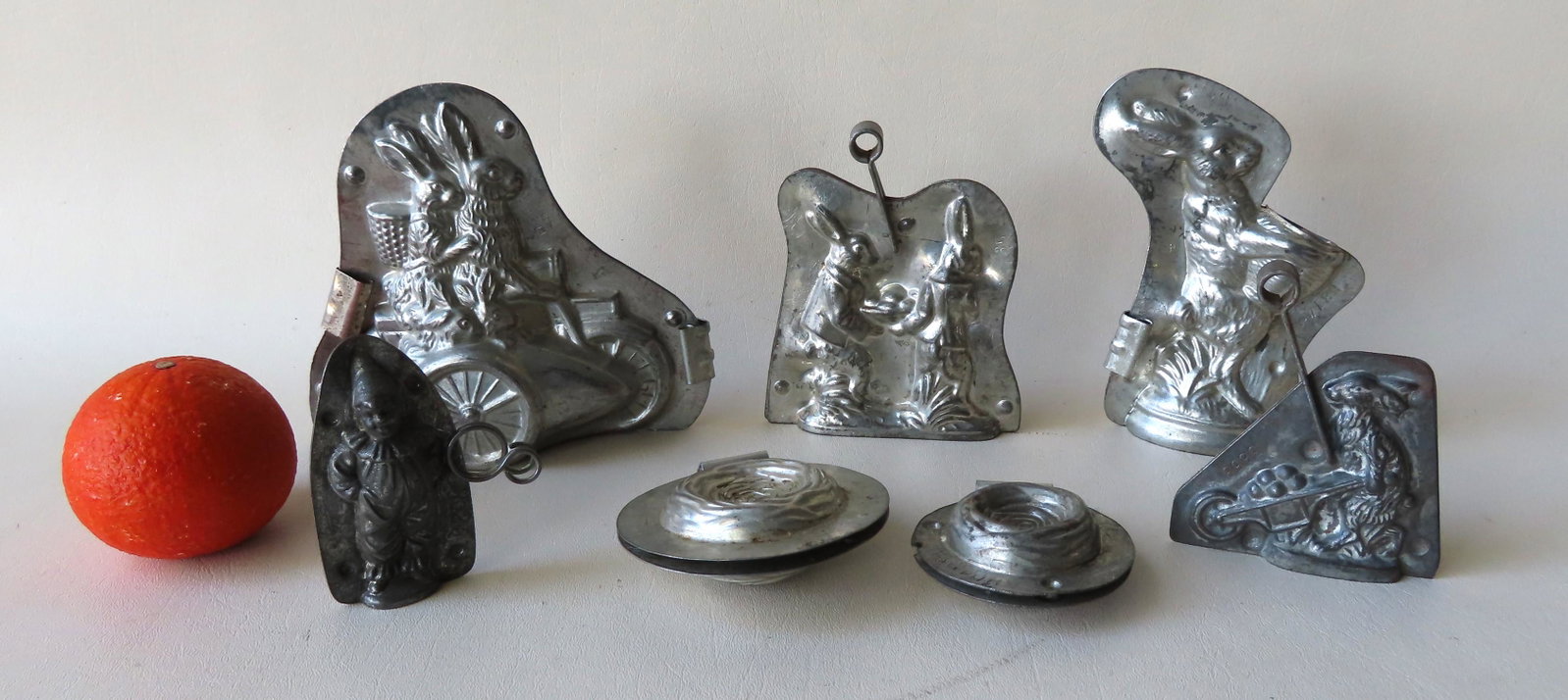 Grouping of 7 Easter related double chocolate molds: Grouping of 7 Easter related double chocolate molds with open bottoms including: Two rabbits riding motorcycles signed "Made in Germany / Gesetzl / Geschutzt" - 7"W x 6"H; a rabbit holding basket no. 