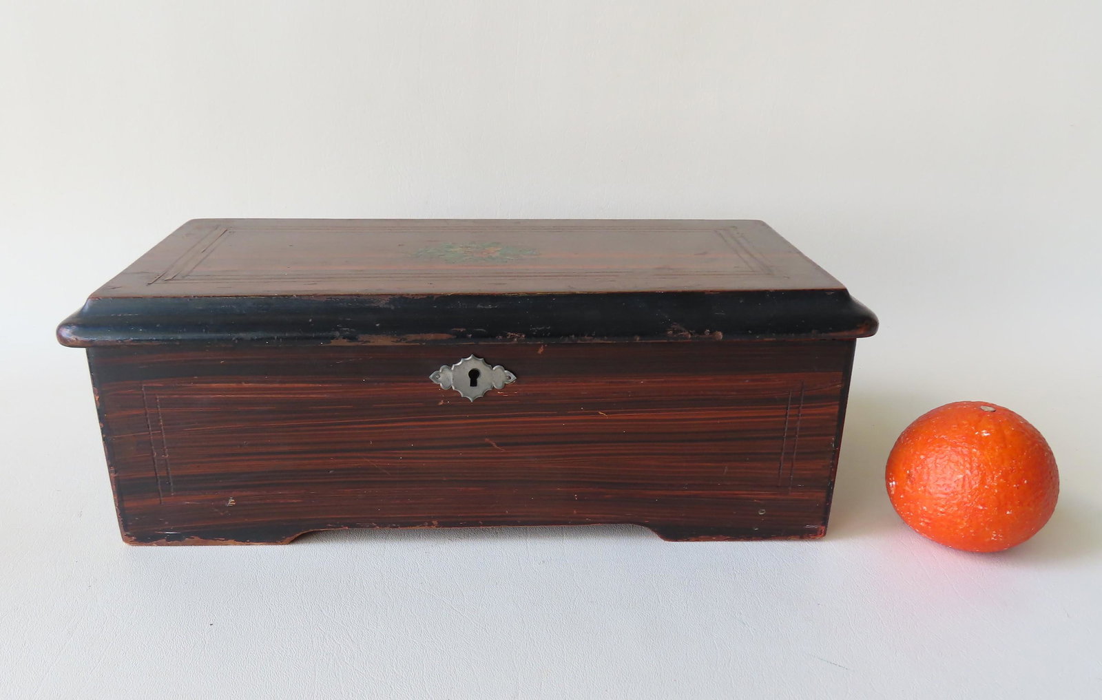 Swiss music box, 6 tune, grain painted rosewood box.: Swiss music box, 6 tune, grain painted rosewood box. Very good working condition. Measures 14 3/4"L x 7 1/4"D x 5"H.
