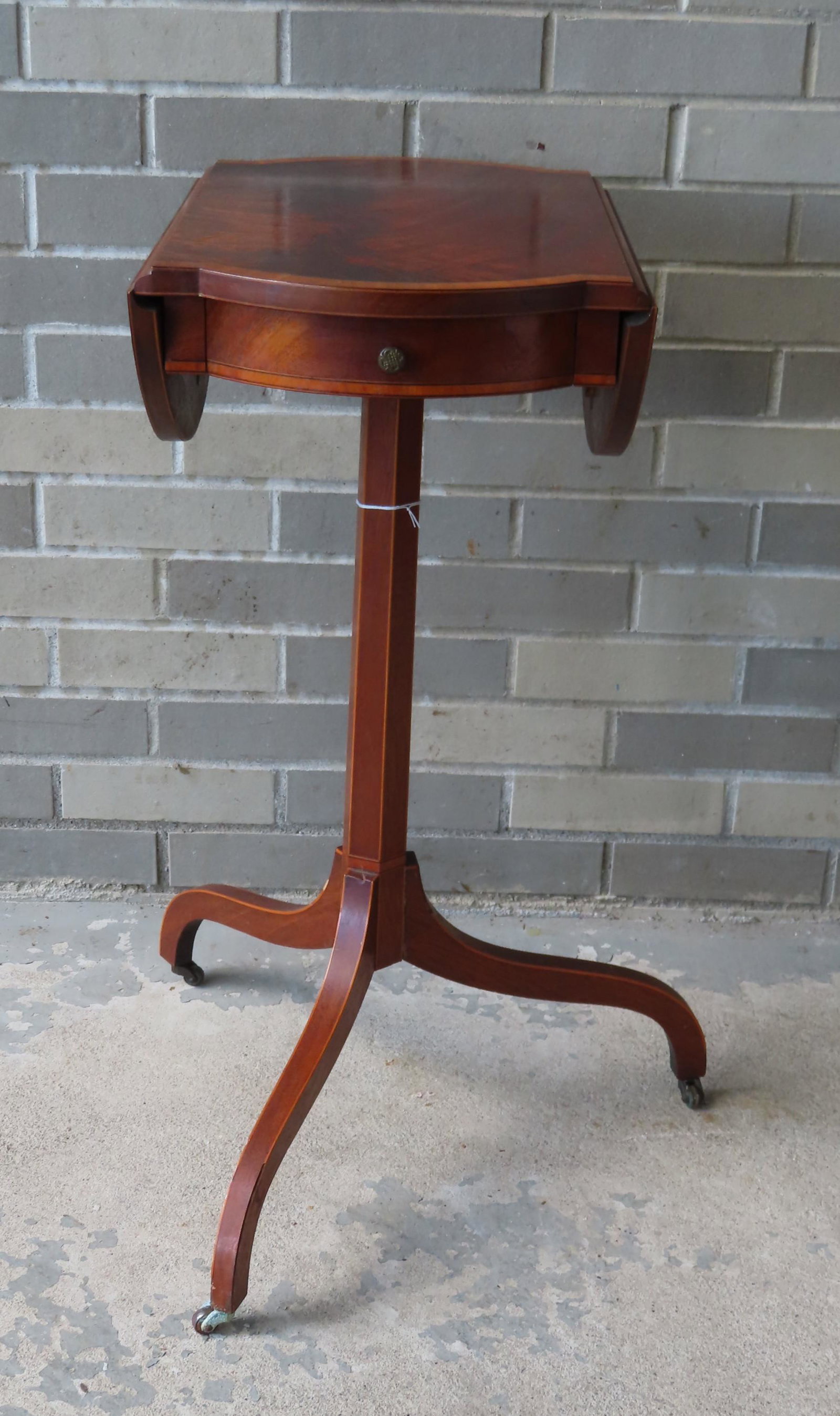 Small Edwardian mahogany drop-leaf candlestand with: Small Edwardian mahogany drop-leaf candlestand with clover leaf top with satinwood banded inlay and single drawer, mounted on hexagonal column leading to 3 spider legs on casters. Very good condition,