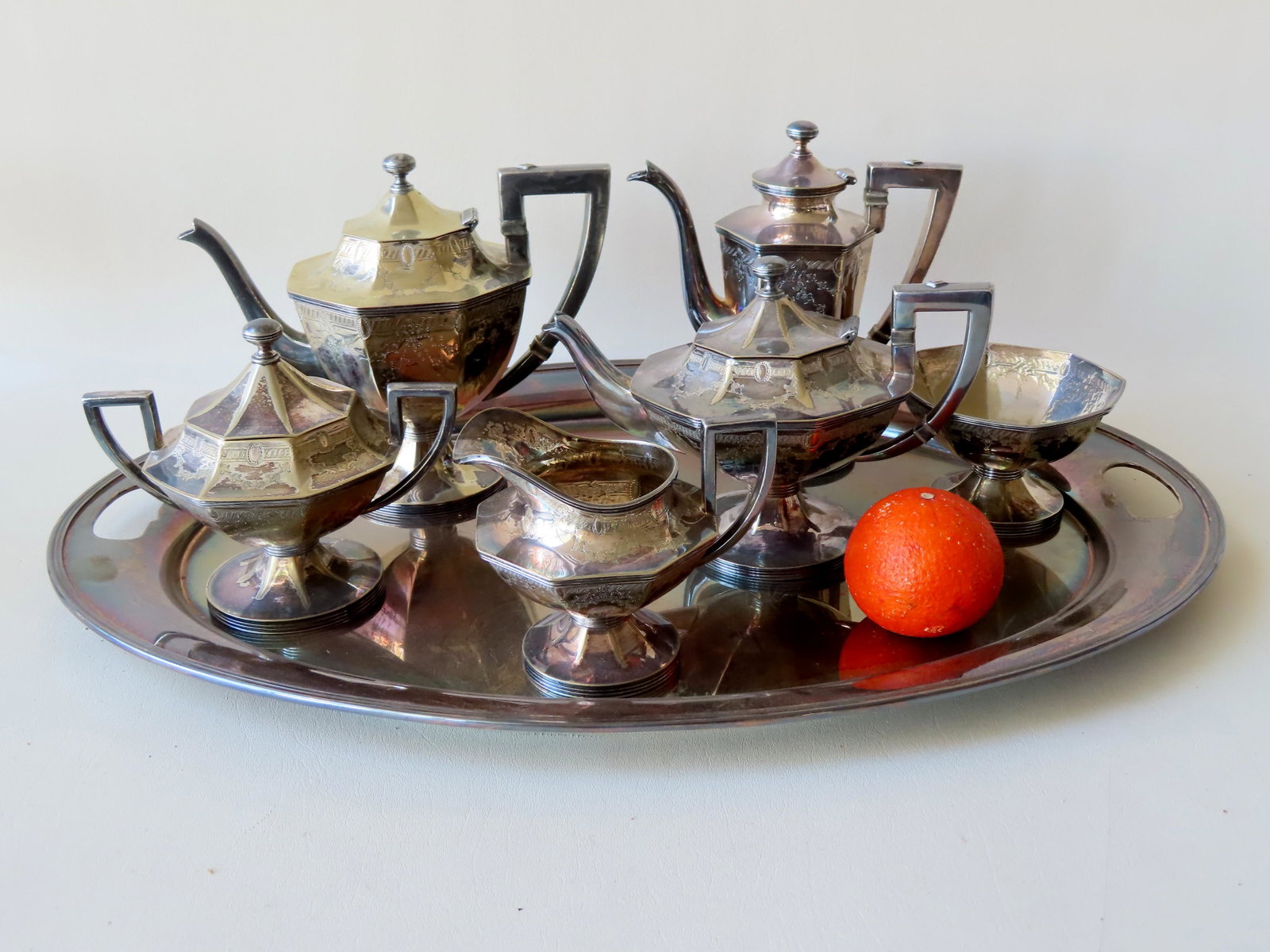 An Art Deco 7 piece silver over copper tea service,: An Art Deco 7 piece silver over copper tea service, circa 1920-30, hallmarks on base of each piece as well as monogram. Includes coffee pot, 2 tea pots, sugar & creamer, waste bowl, and a non-matching