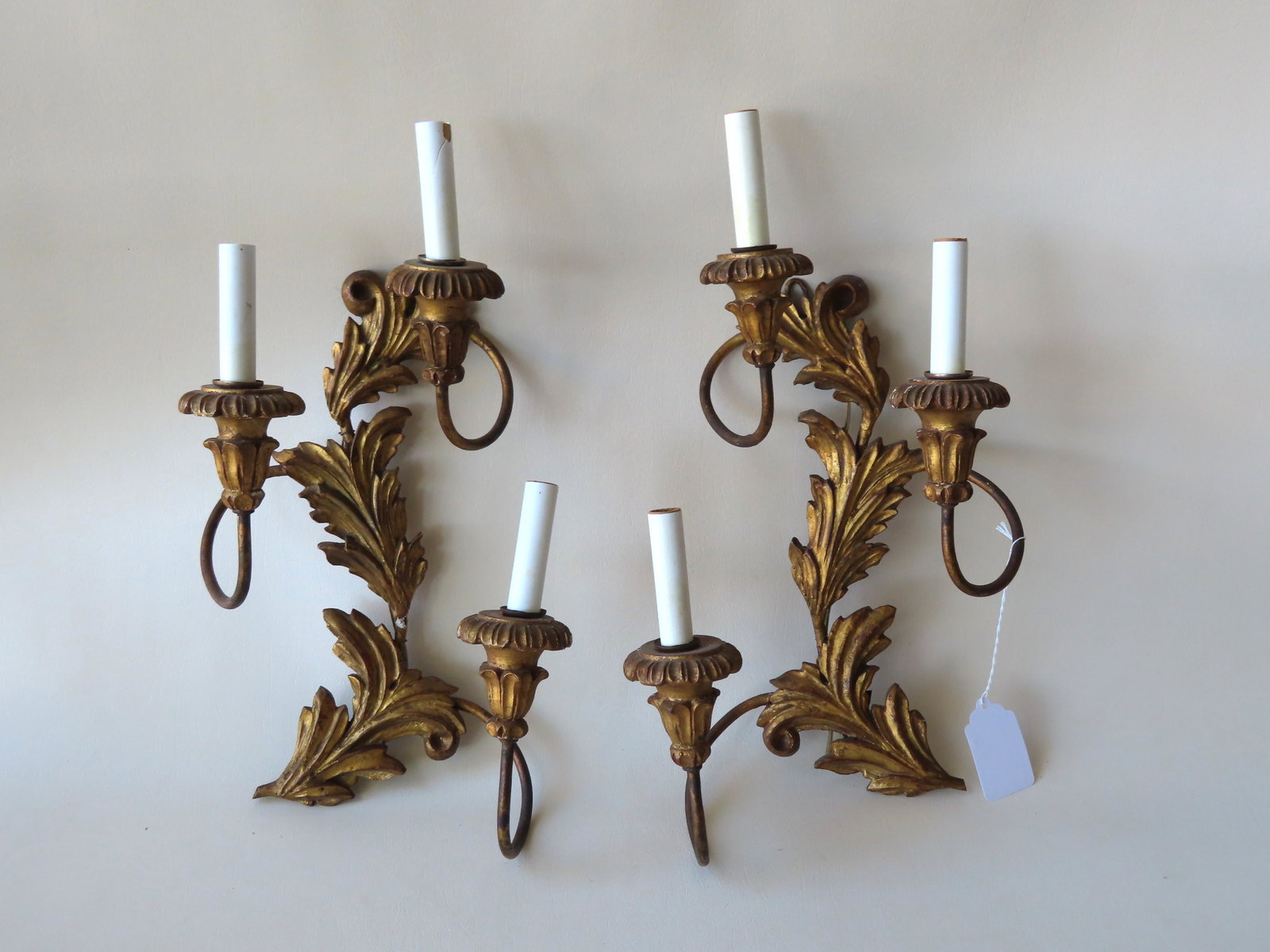 Two matching gilt gesso carved wood wall sconces in the: Two matching gilt gesso carved wood wall sconces in the form of leaves, each with 3 floral candle holders - late 18th to mid 19th century - electrified, several small cracks, overall good condition. E