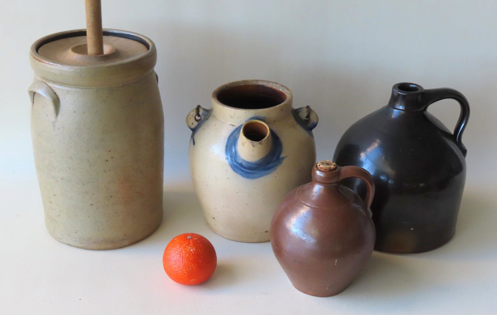 Grouping of 4 pieces of stoneware including butter: Grouping of 4 pieces of stoneware including butter churn - 12"H with wooden dasher that measures 40"H - the dasher, the carved wooden lid and the stoneware churn all in very good condition; 1 gallon j