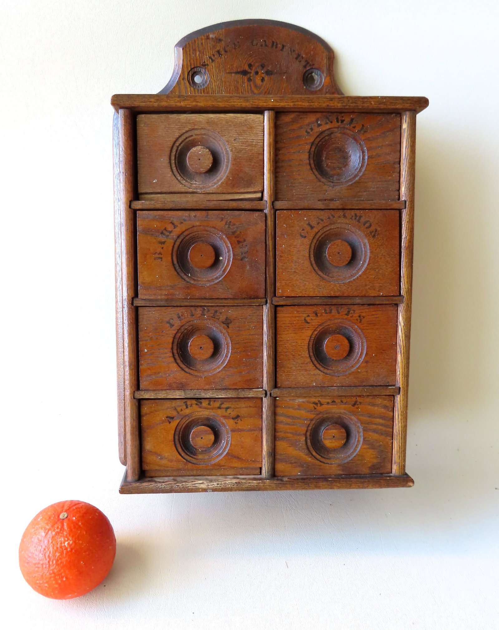 Hanging oak spice box with 8 drawers and original: Hanging oak spice box with 8 drawers and original stenciling, late 19th century - 2 drawers with minor losses, else good condition in original finish. Measures 18"H x 11"W x 5" deep.