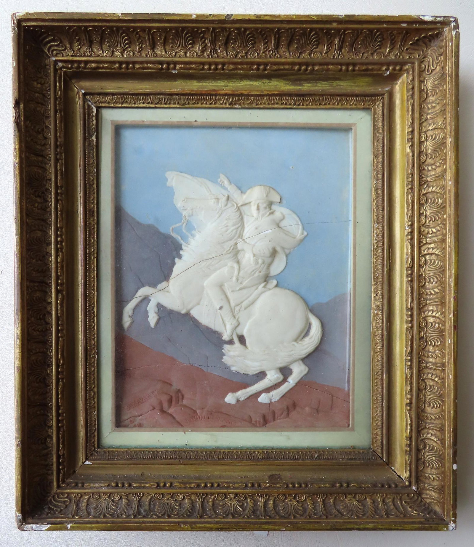 A hand painted plaster and porcelain relief sculpture: A hand painted plaster and porcelain relief sculpture of Napoleon Bonaparte on horseback crossing the Alps after the famous painting by French artist Jacques-Louis David (1748-1825), and with incised 