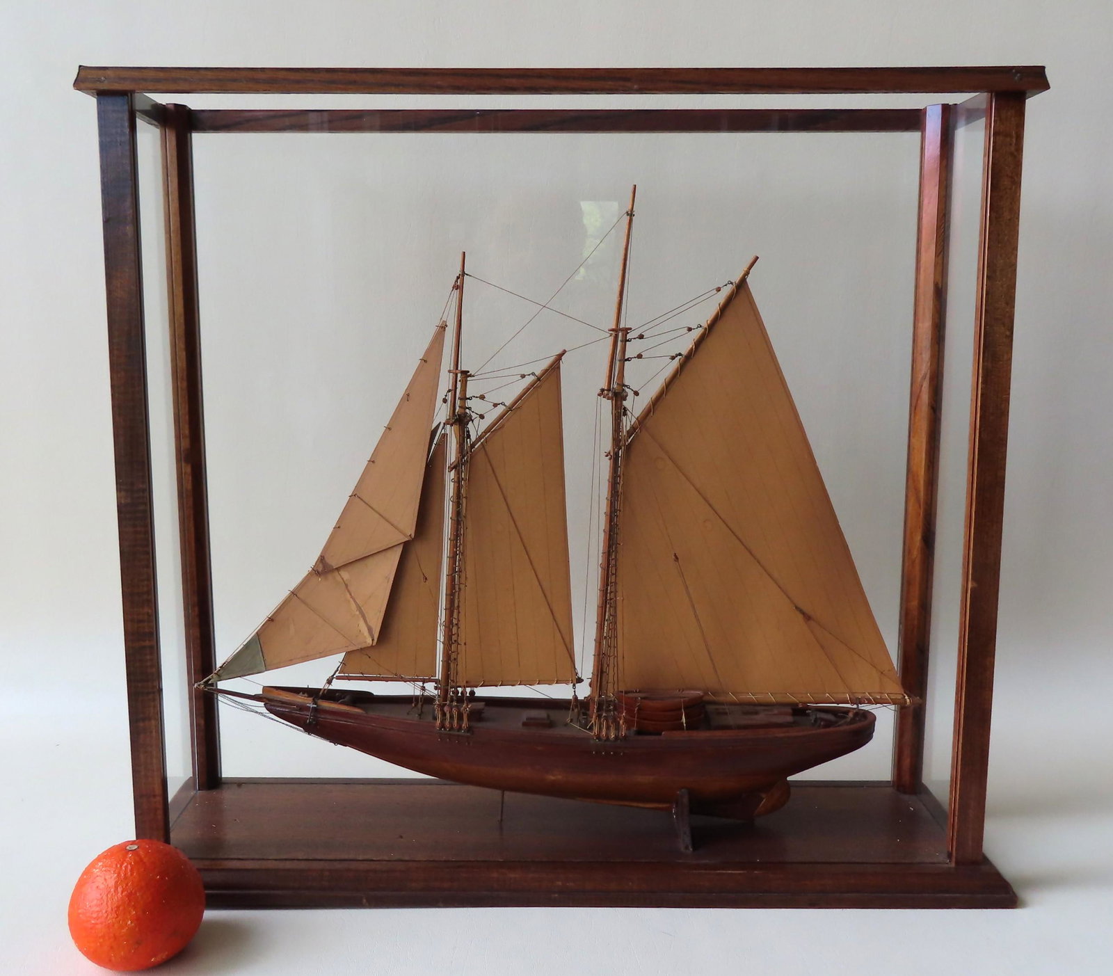 Wooden model of Canadian Bluenose racing schooner,: Wooden model of Canadian Bluenose racing schooner, fully rigged with sails and life boats, probably early to mid 20th century. Mounted within a glass display case with wood frame, mid to late 20th cen