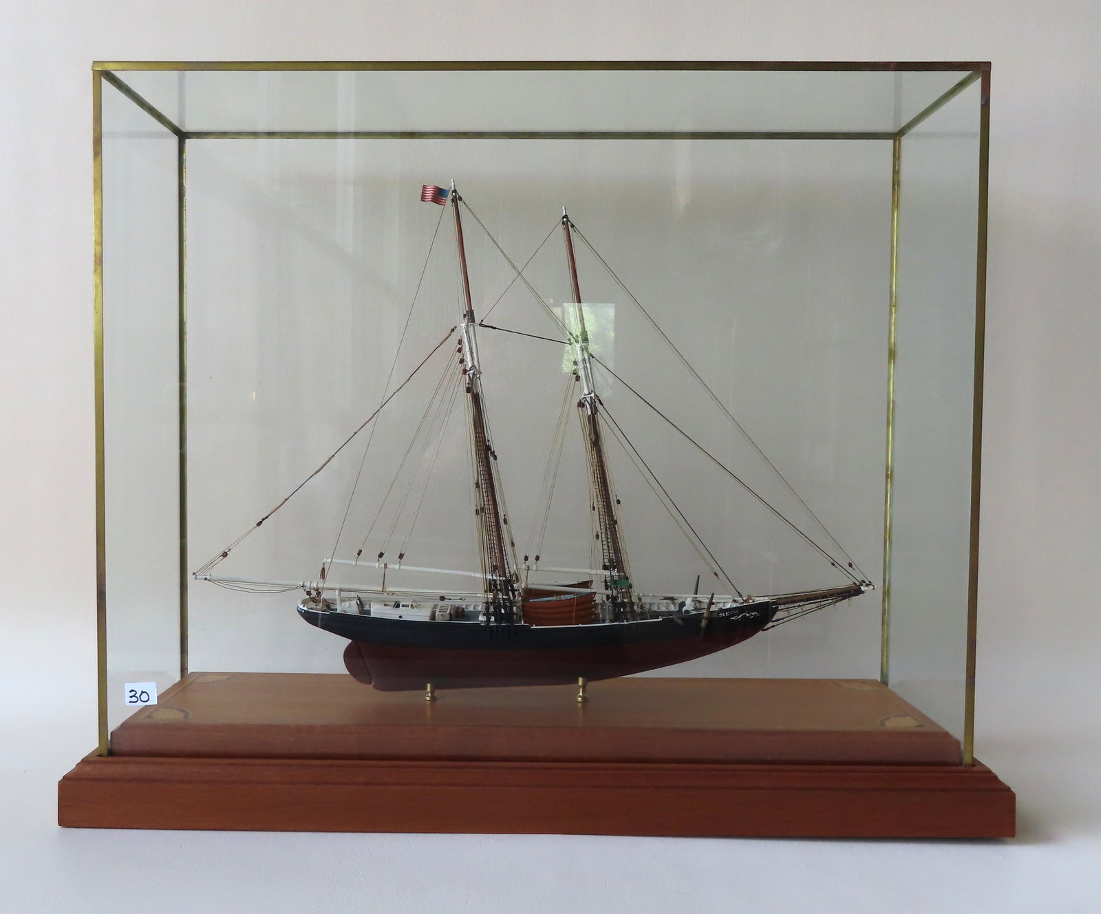 Wooden ship model of fishing schooner "Elsie": Wooden ship model of fishing schooner "Elsie" originally built in 1910 as part of the Gloucester Massachusetts fishing fleet, and containing 8 lifeboats, mounted in a wood and glass case. Very good co