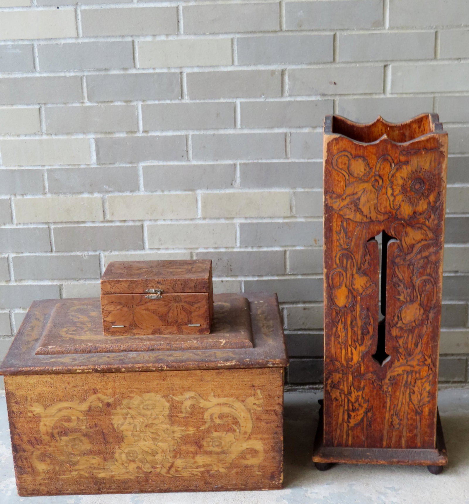 Three Flemish art wooden articles decorated with: Three Flemish art wooden articles decorated with flowers in the Art Nouveau style. Includes: An umbrella stand - partial loss to one section of molding at base - 27"H x 8 3/4" square; a storage box me